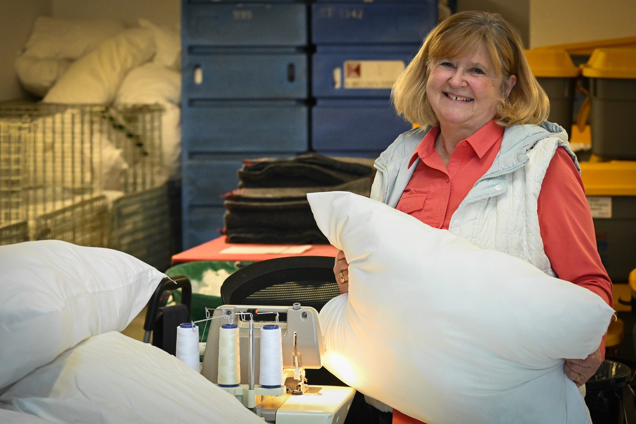 Happy volunteer carrying a pellow