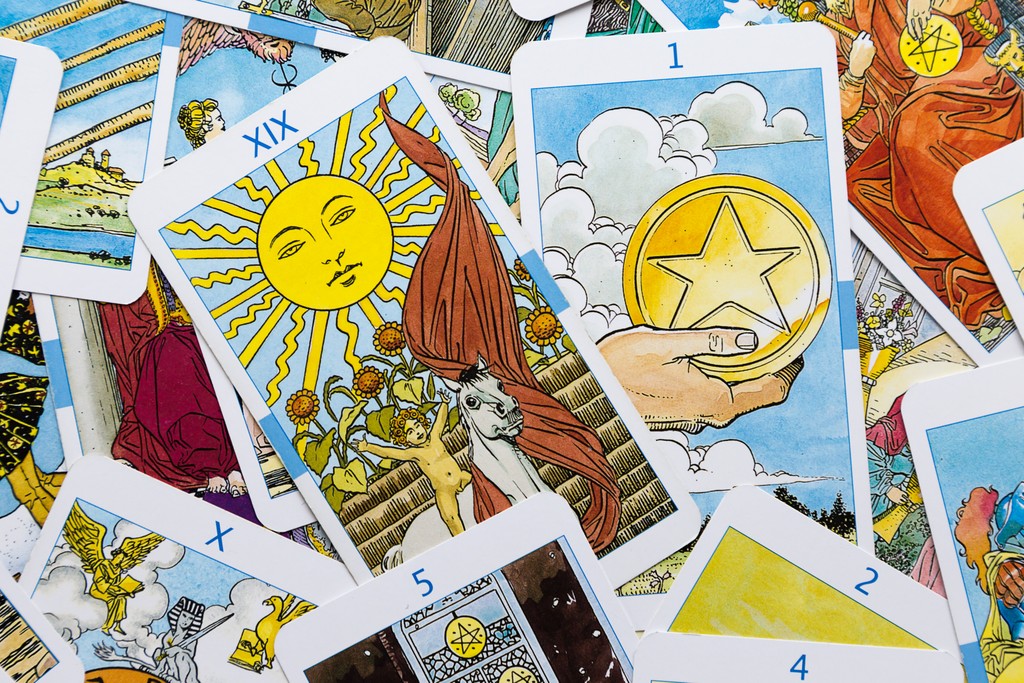 Person sitting cross-legged in casual clothing using a smartphone.