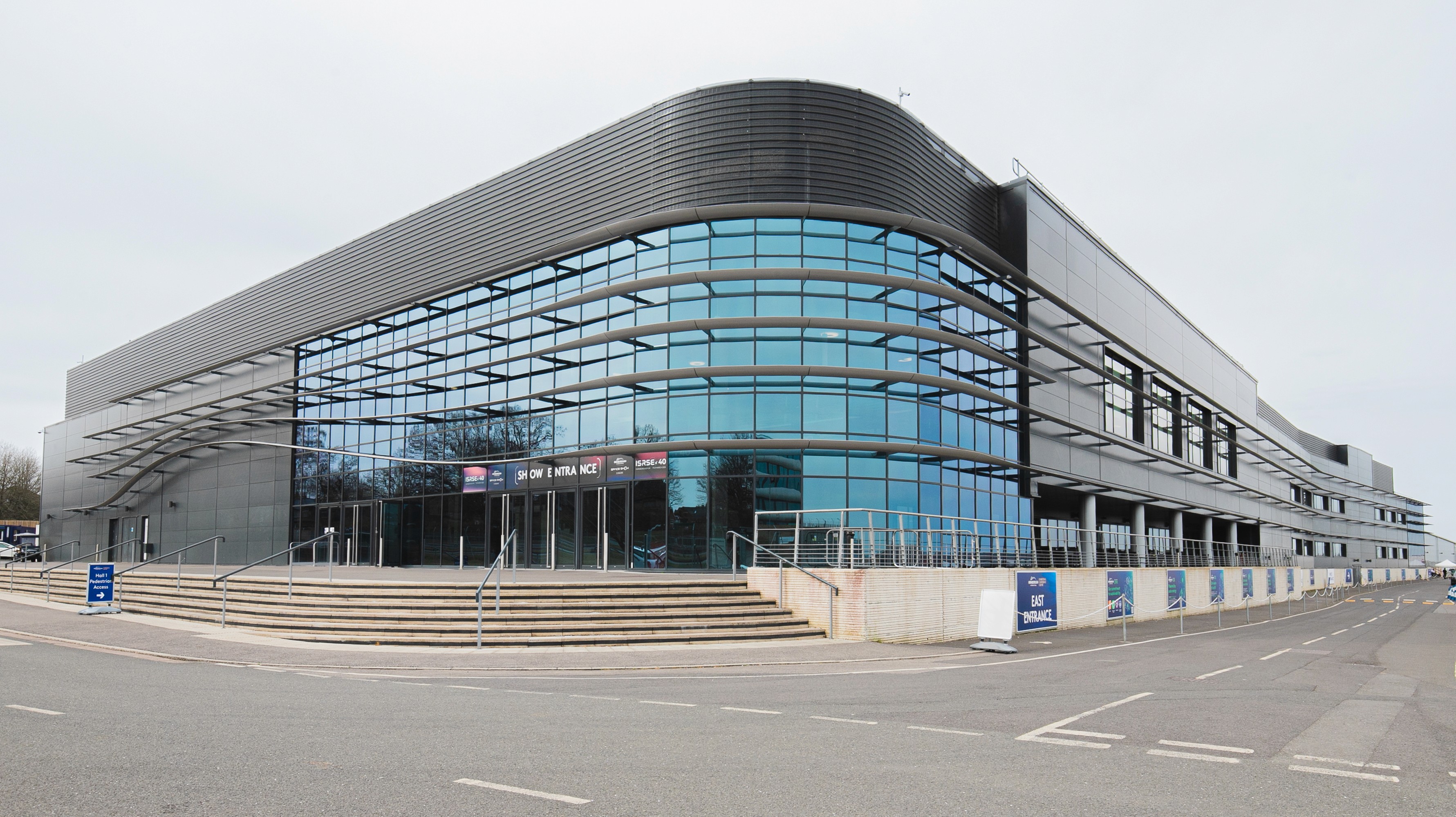 Two classic volkswagen beetles, one green, one cream.