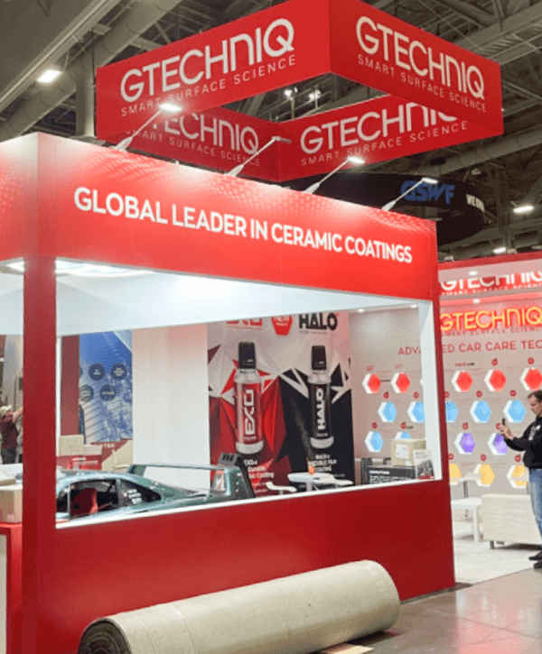 Large SEMA booth overview with open vehicle display area, wide circulation space, and strong automotive brand presence