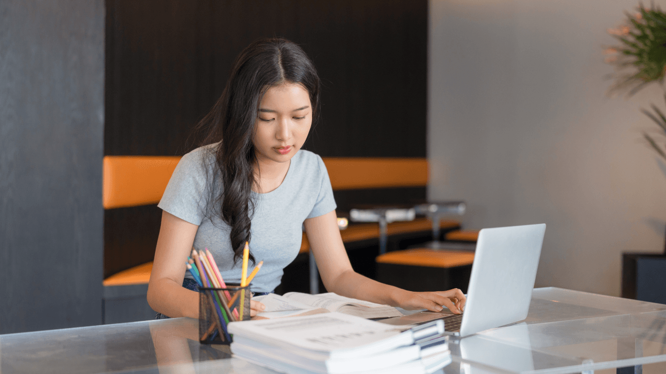 A cozy scene with warm sunlight casting stripes, featuring a potted plant and soft towels on a window sill.