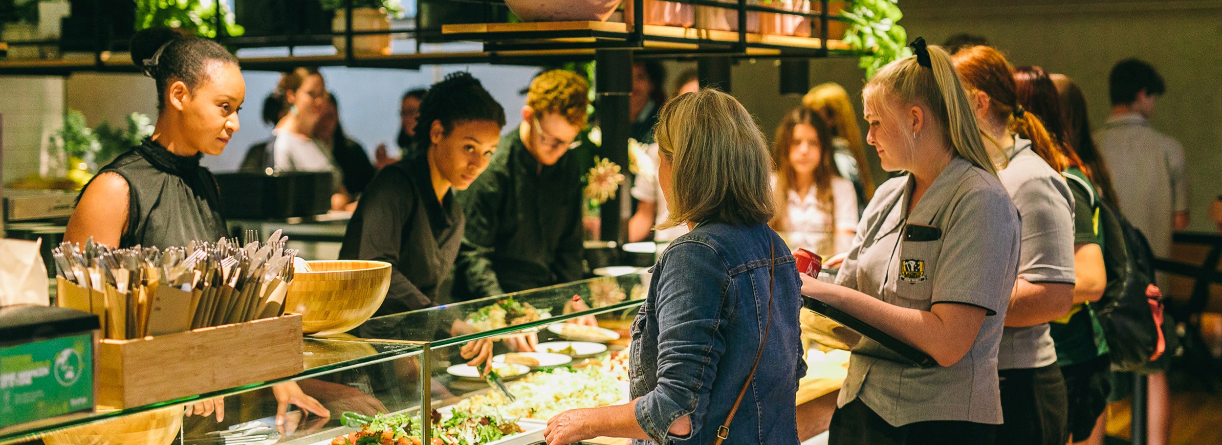 Staff serving healthy buffet options to guests