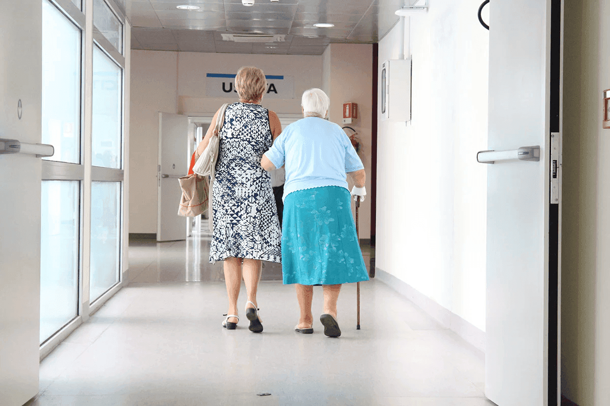 Older adult walking with support, showing how sarcopenia can affect strength and mobility