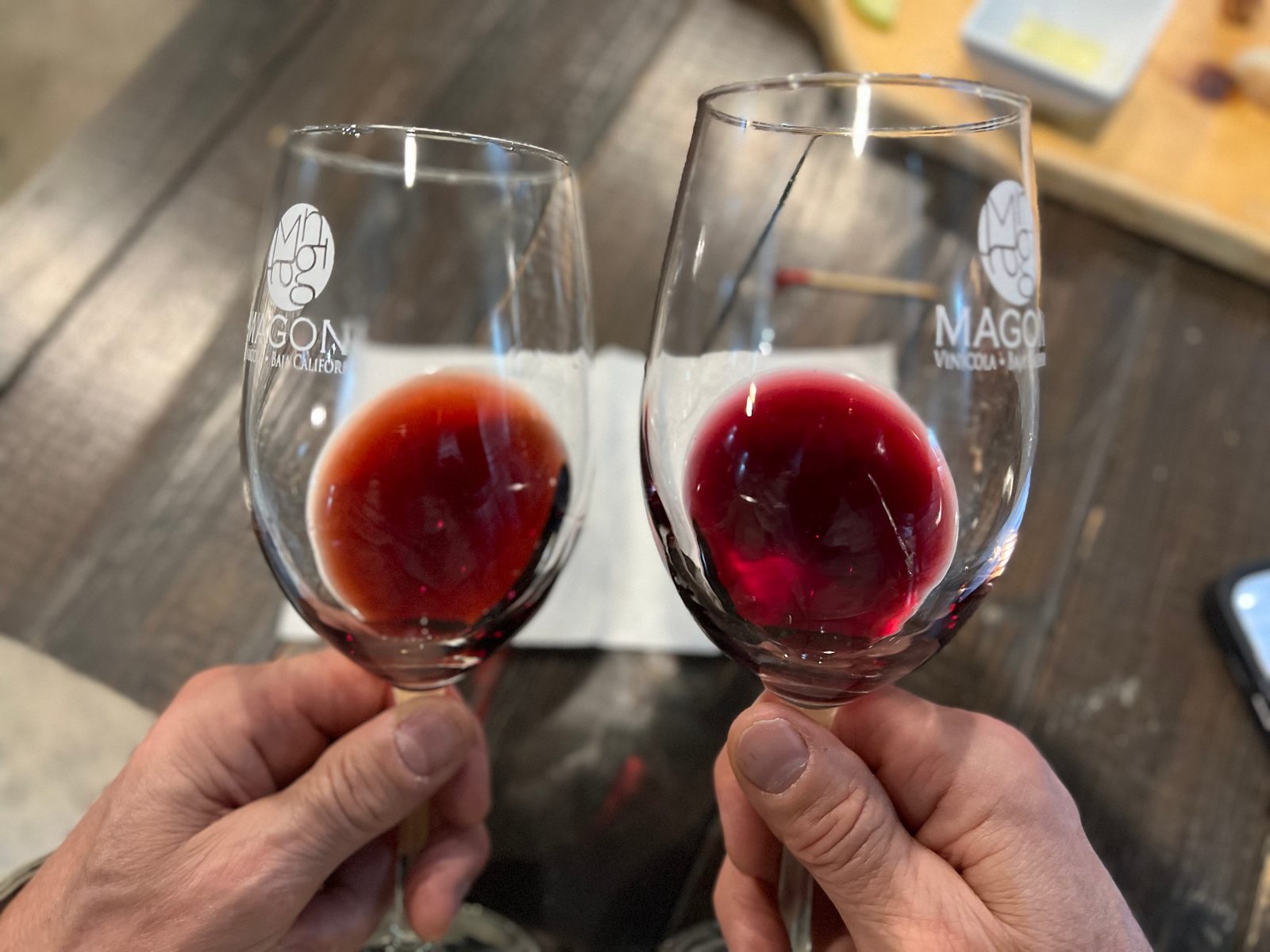 Two glasses of wine being compared side by side.
