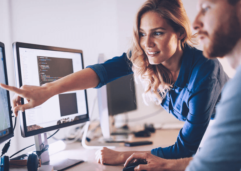 Man and woman looking at a screen