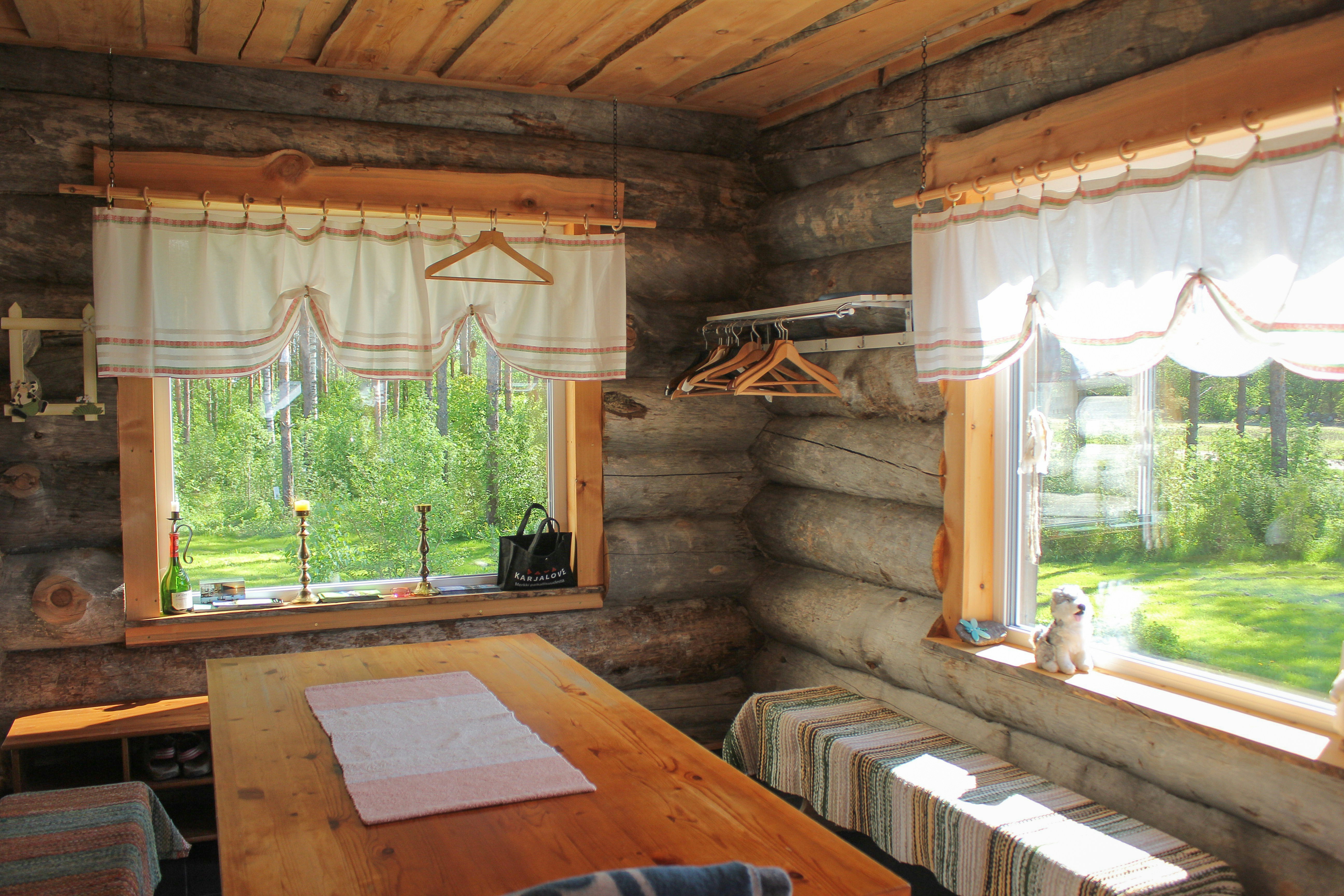 Bedroom with a large window overlooking a forest.