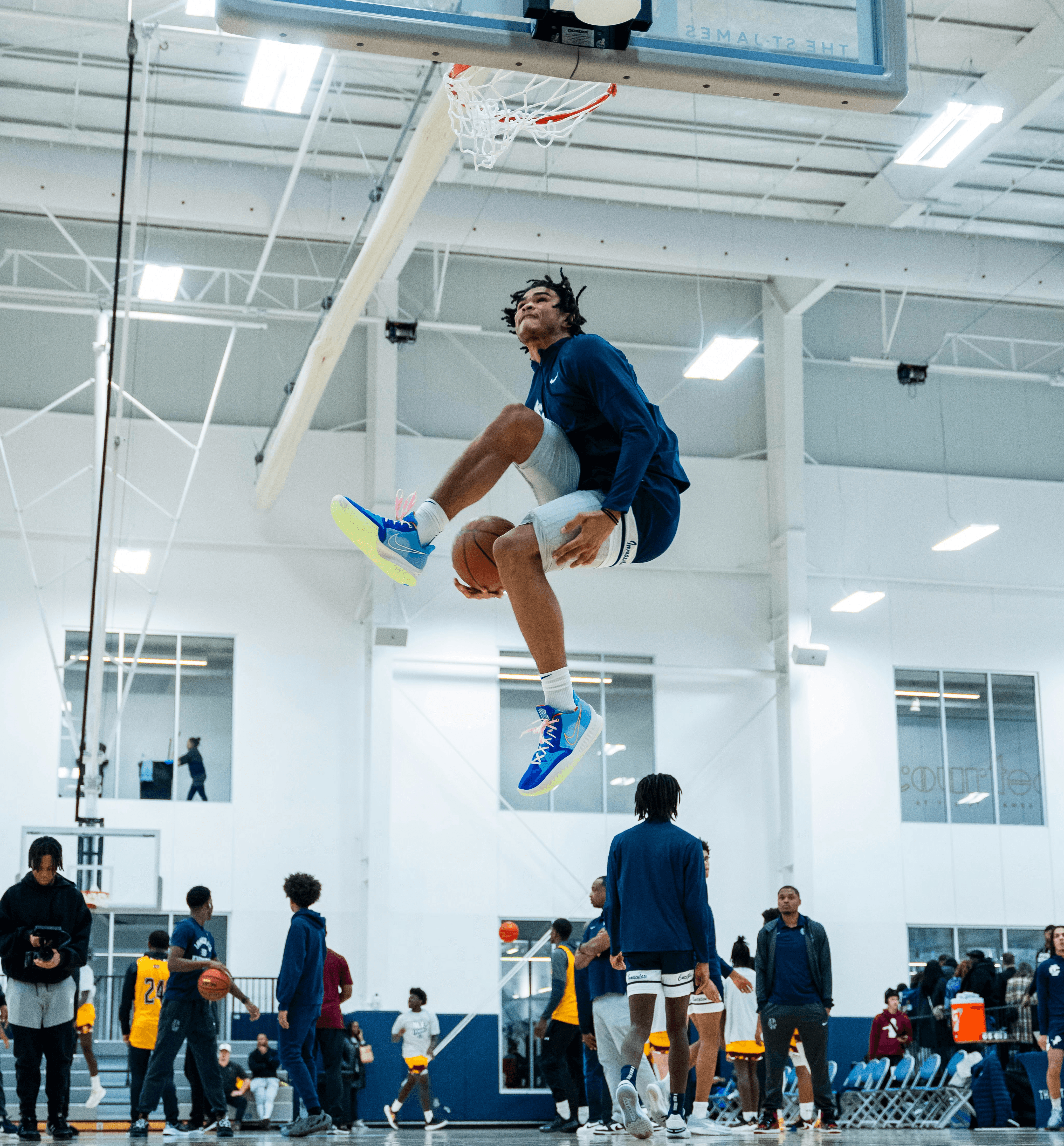 A man jumping up into the air while playing basketball