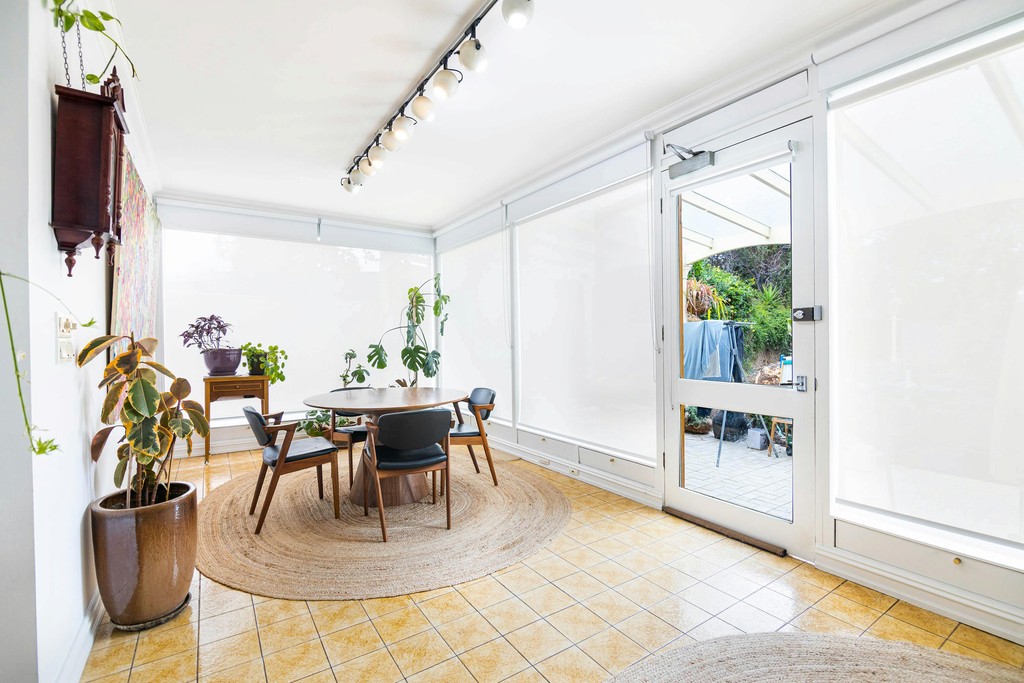 Living area with timber and leather dining table and chairs