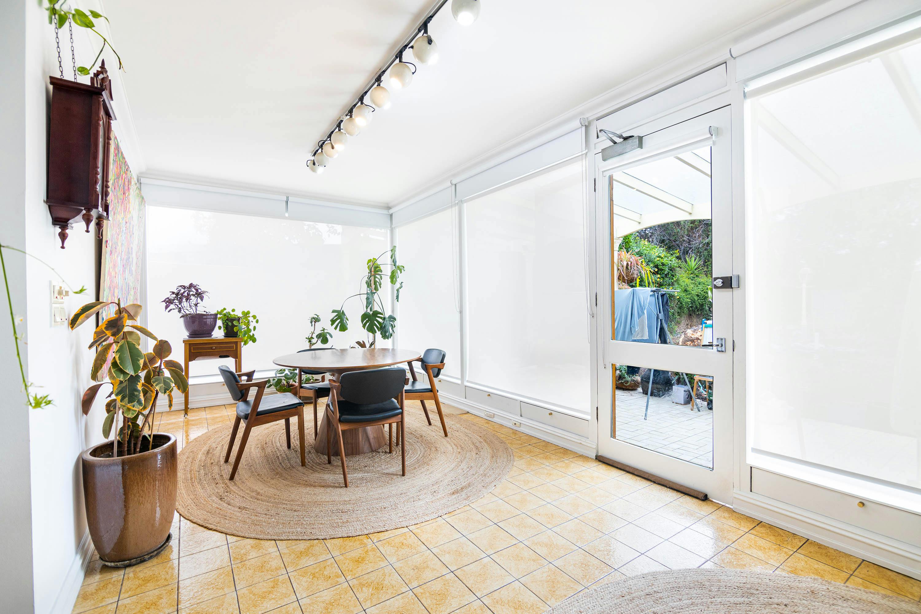 Living area with timber and leather dining table and chairs