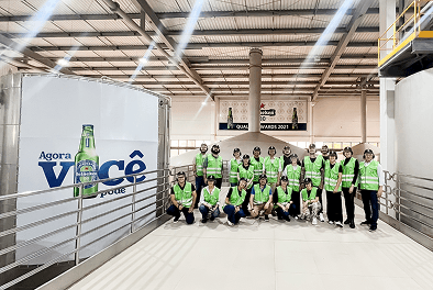 grupo de pessoas com colete verde refletivo posando para uma foto