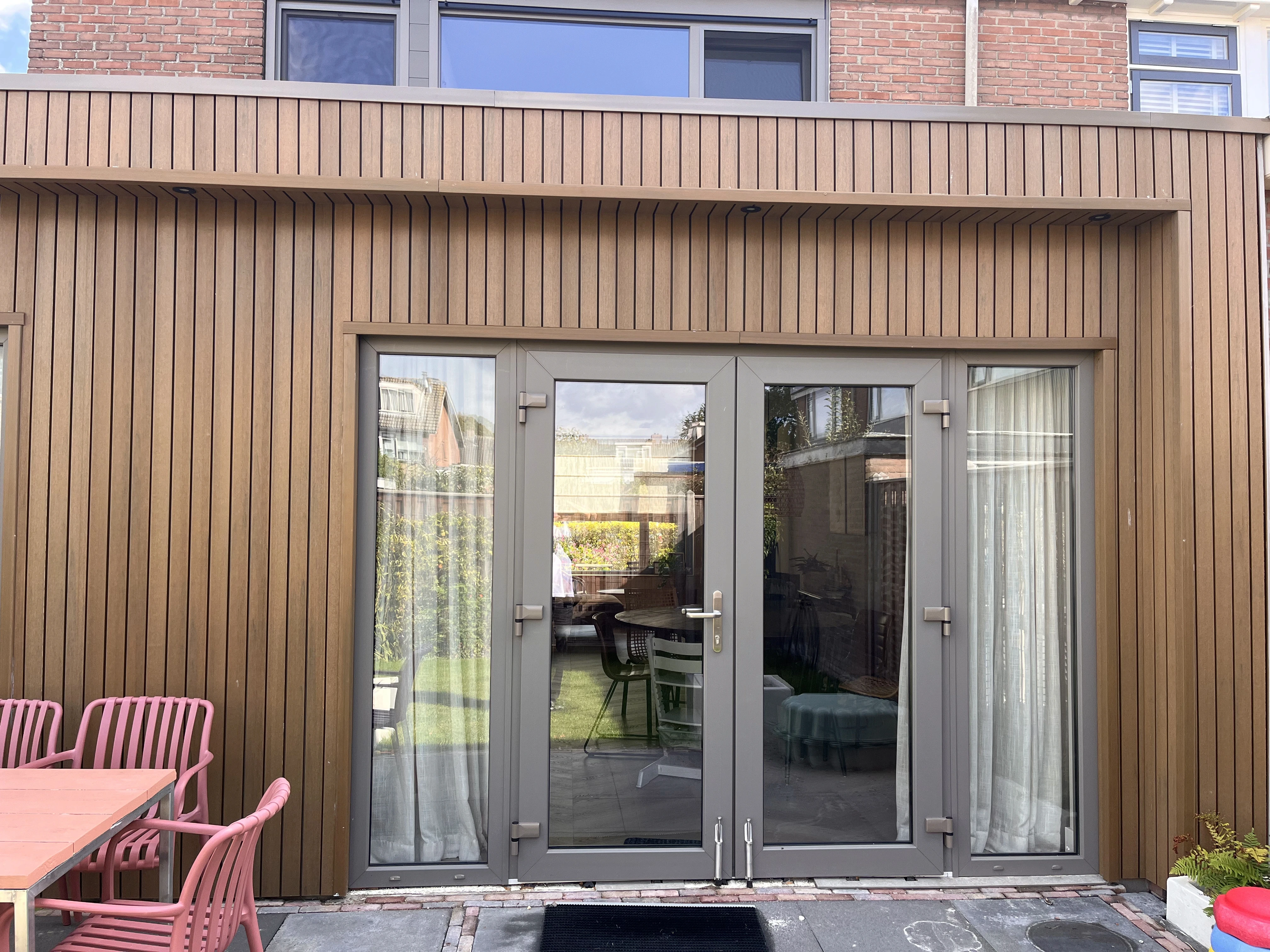 utility man standing in scissor platform cleaning glass window