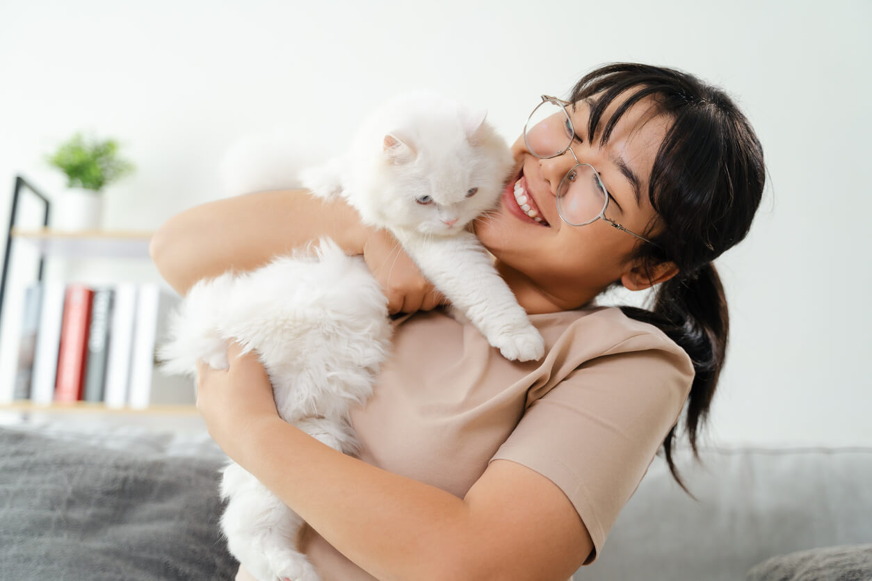 happy Asian girl with fluffy white cat