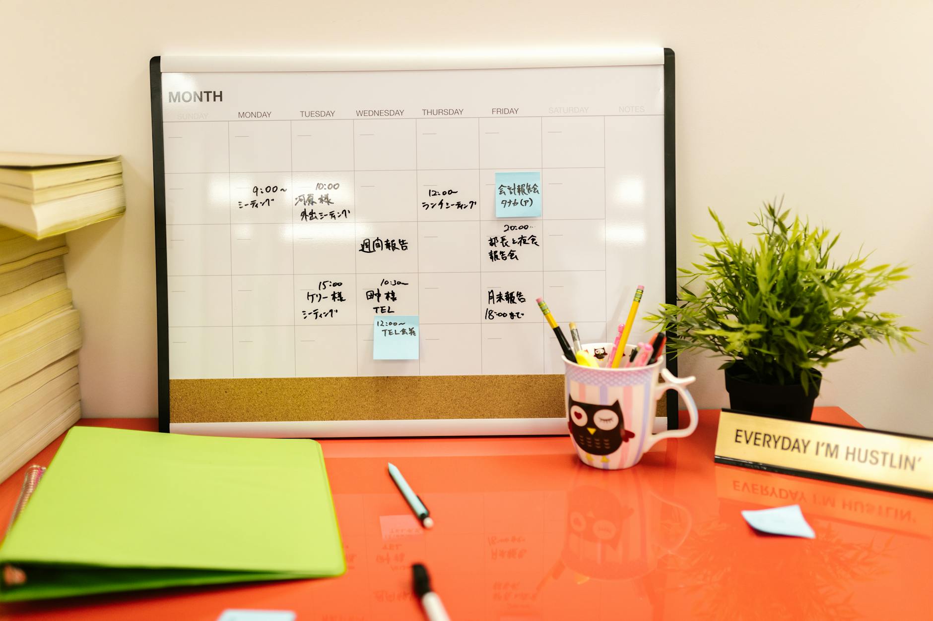 A wall-mounted calendar with colorful sticky notes showing the phases of a project based curriculum timeline.