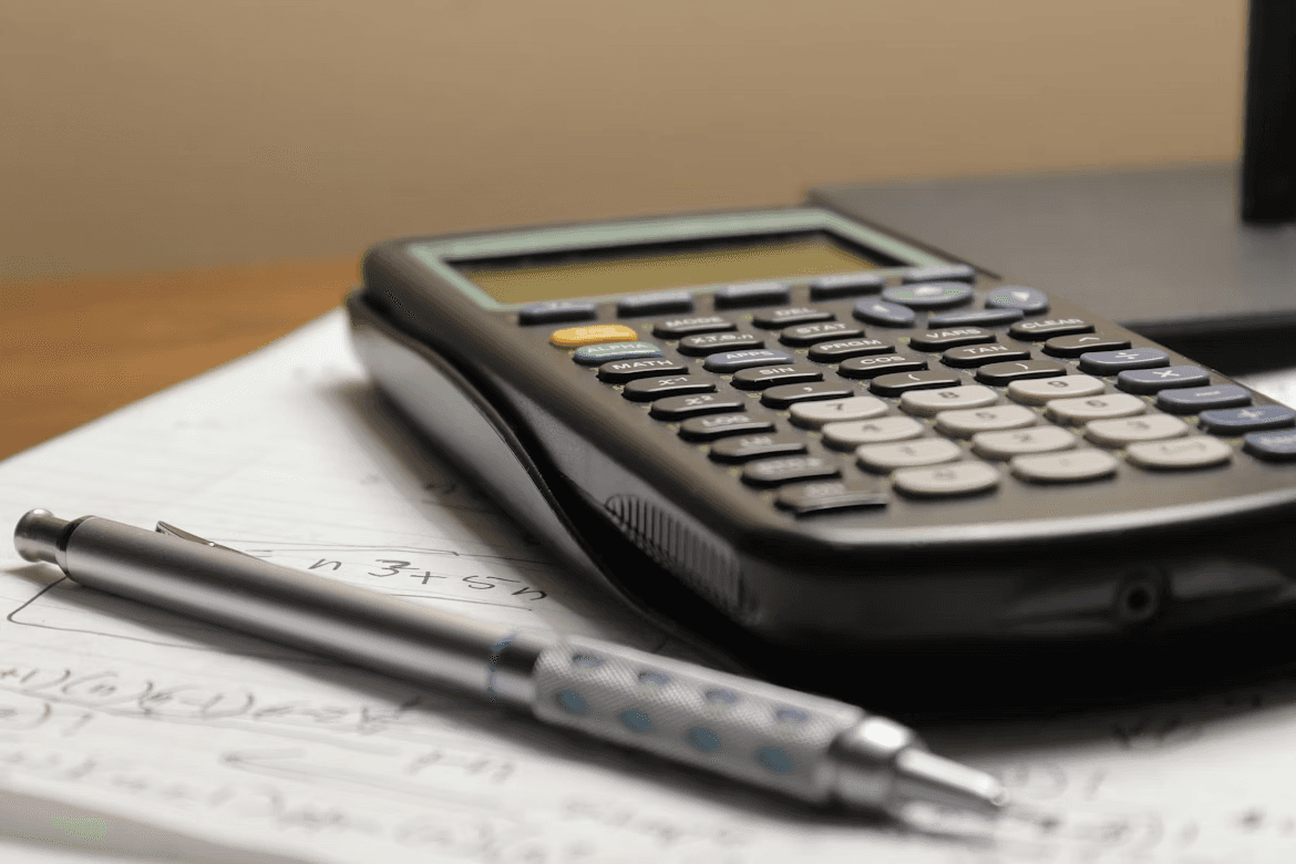 Calculator and pen on top of paperwork during legal cost review