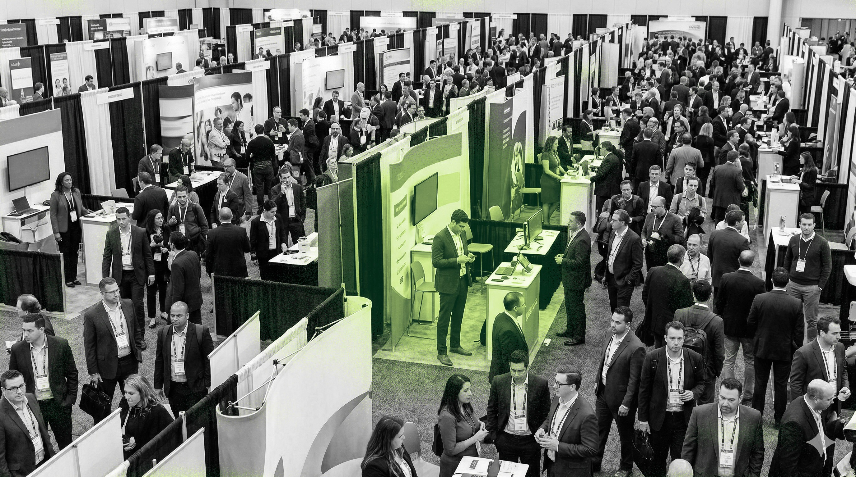 Busy convention hall with exhibition booths and professionals networking at a trade show.