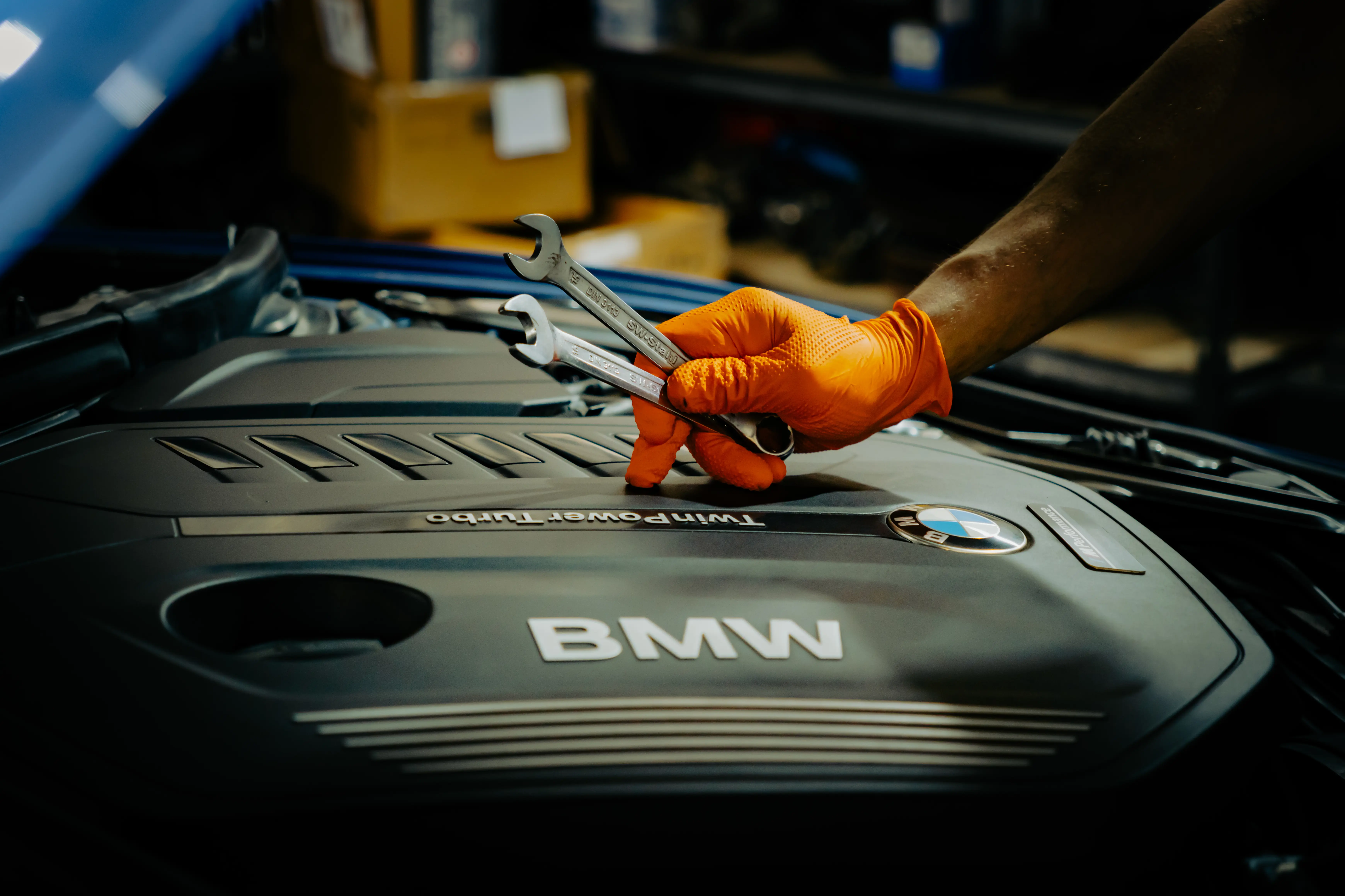 Mobile auto mechanic performing on-site engine repair