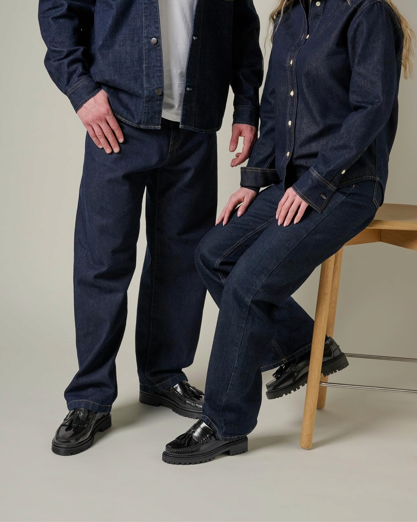 Le bas de la silhouette de 2 personnes qui portent du denim et des mocassins à grosses semelles