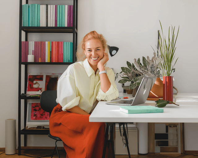 Portrait of a woman in a beige shirt, representing a satisfied Corela client