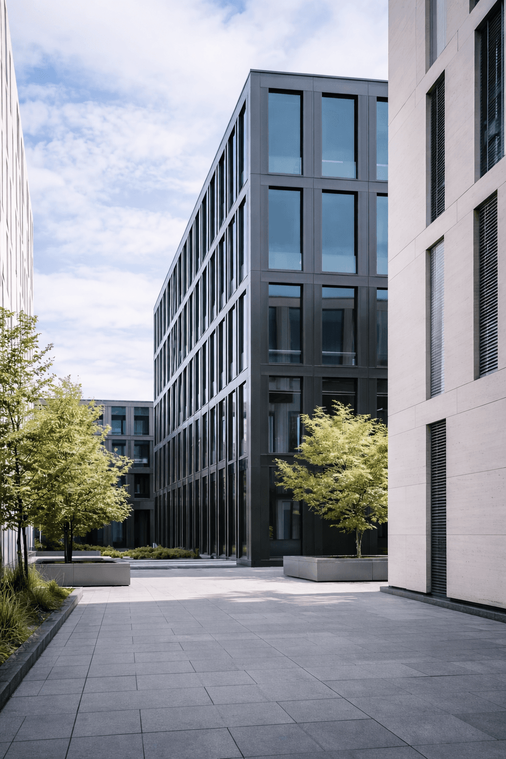 MUNiQ Design Head Office in Munich. Modern glass facade of the central campus, representing automotive design strategy and digital leadership.