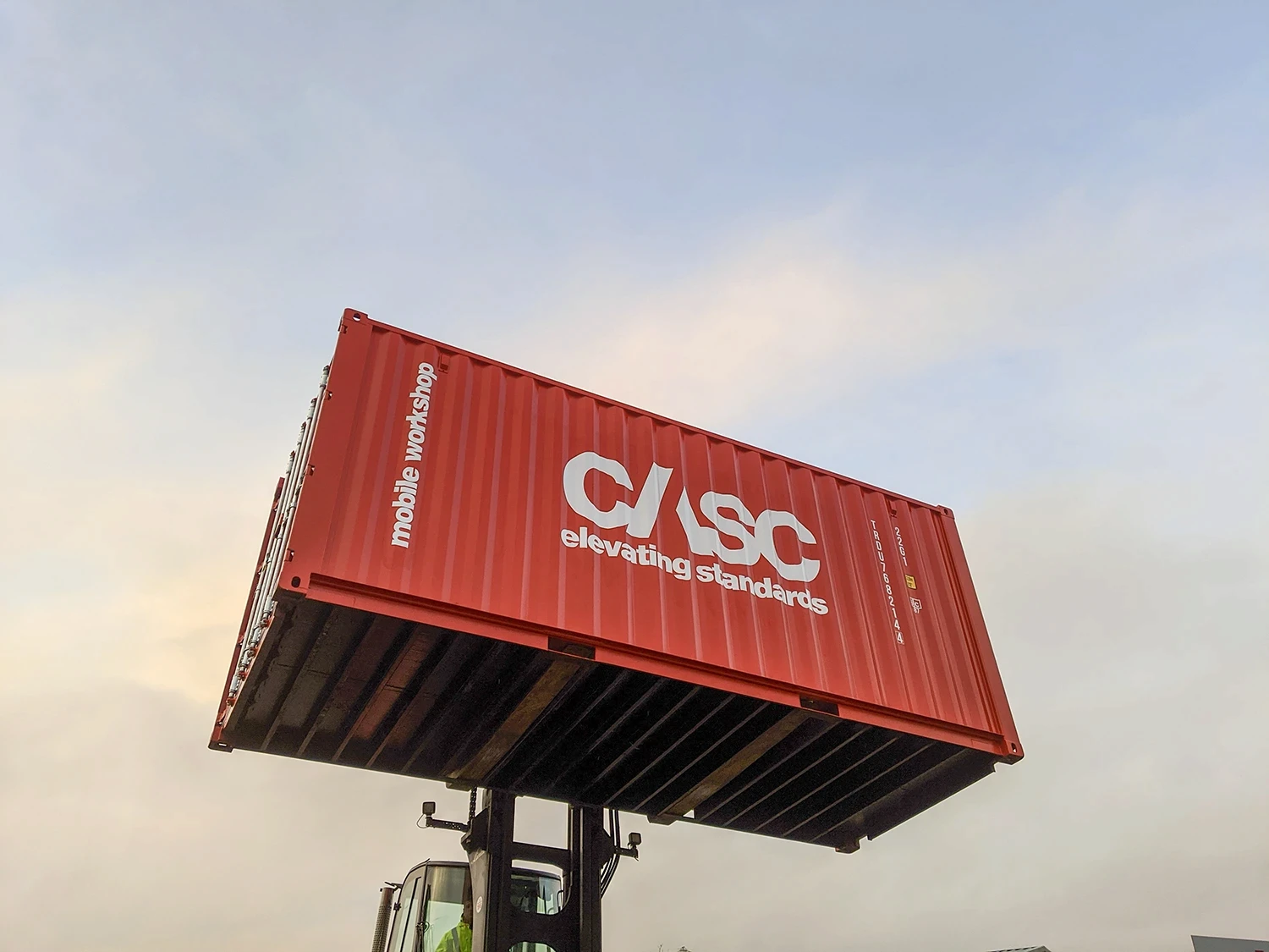 CASC mobile workshop container being lifted into position on an industrial site.