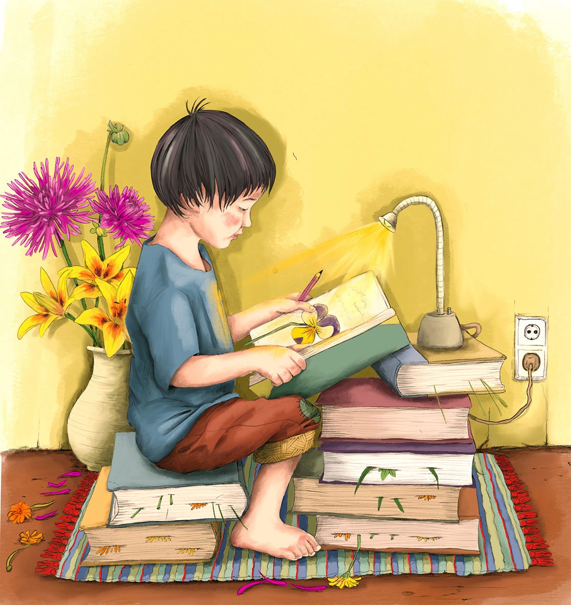 Ein Junge sitzt aufeinem Stapel Bücher und presst Blumen