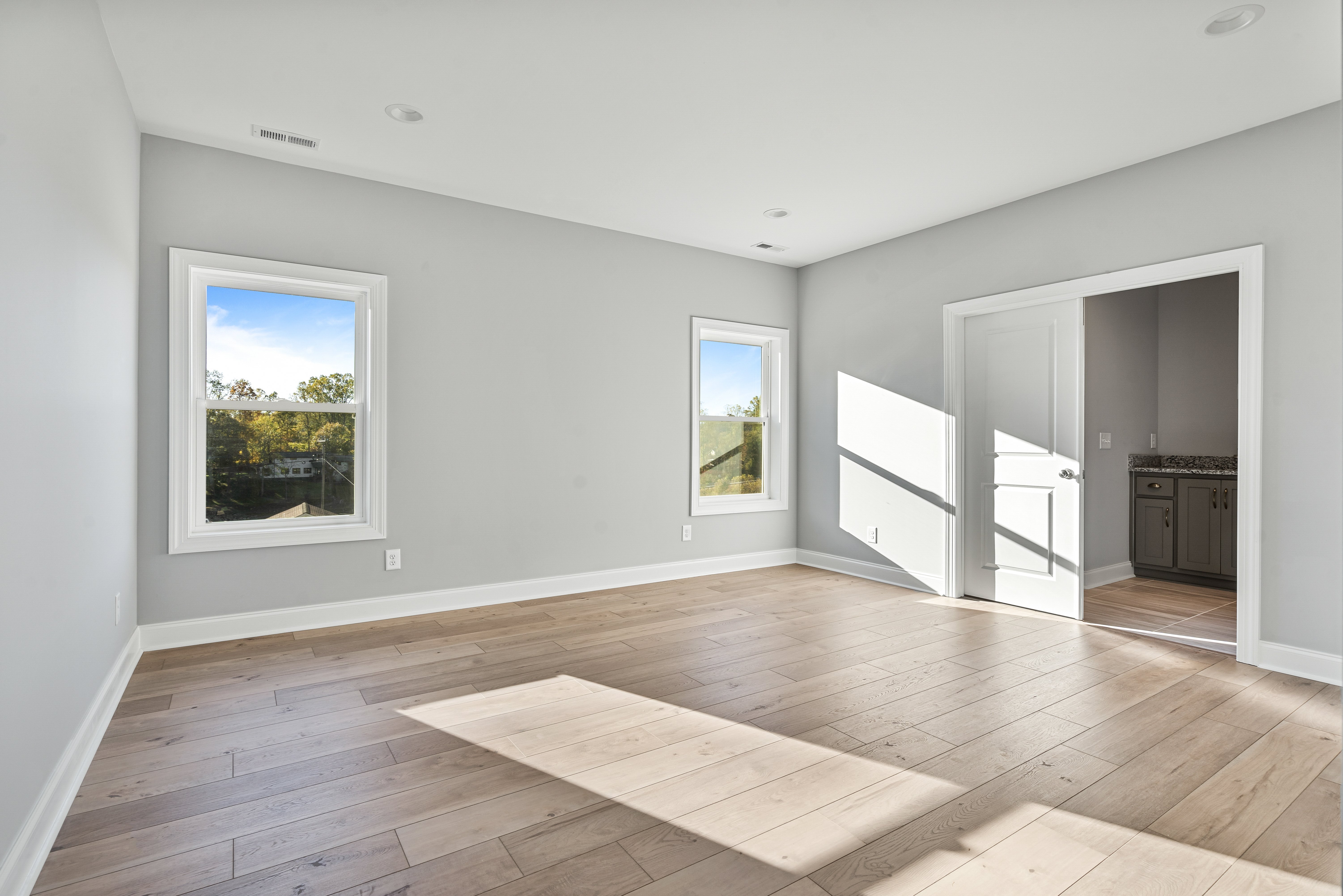 Spacious living room with vaulted ceilings and hardwood floors