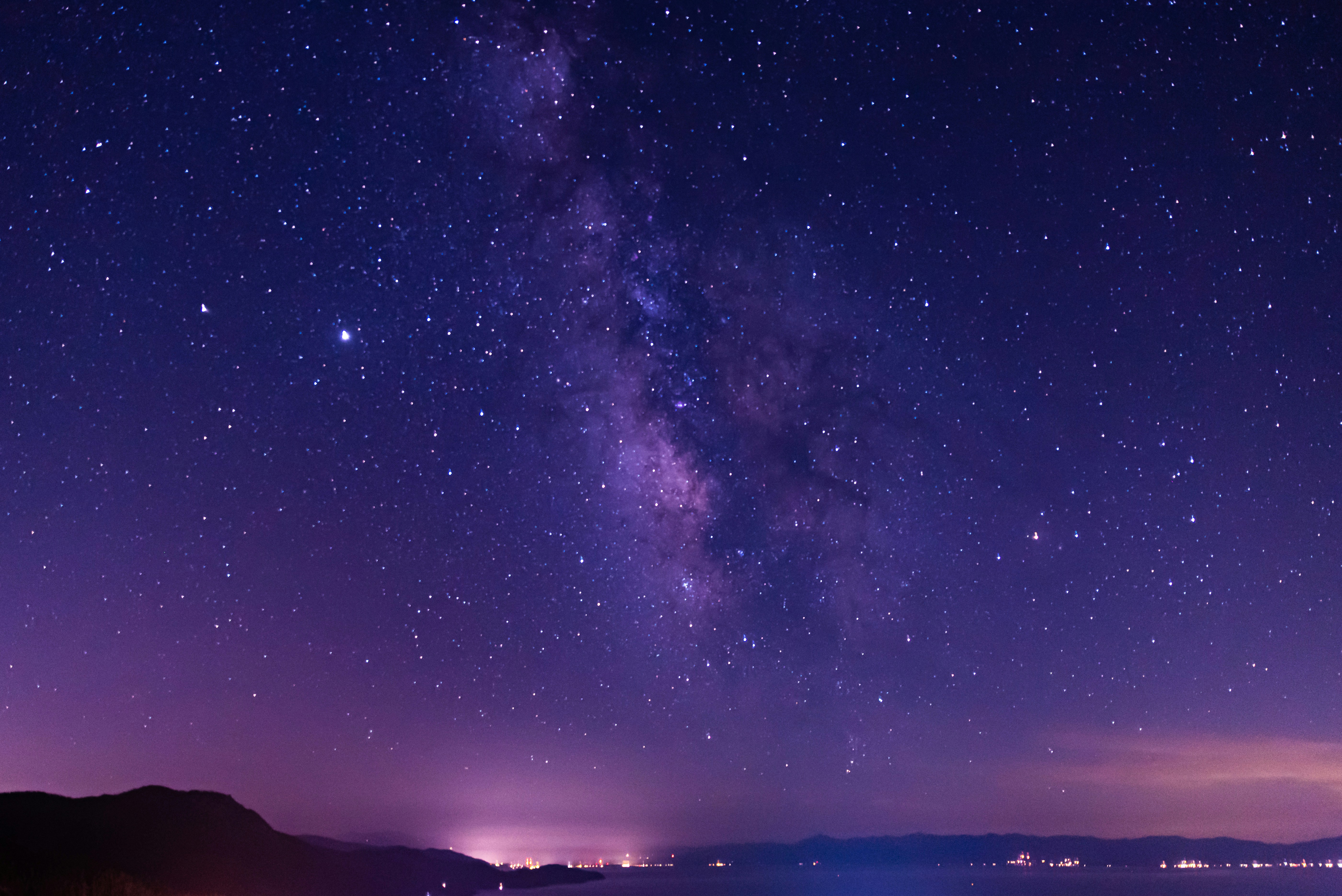 silhouette of mountain under starry night
