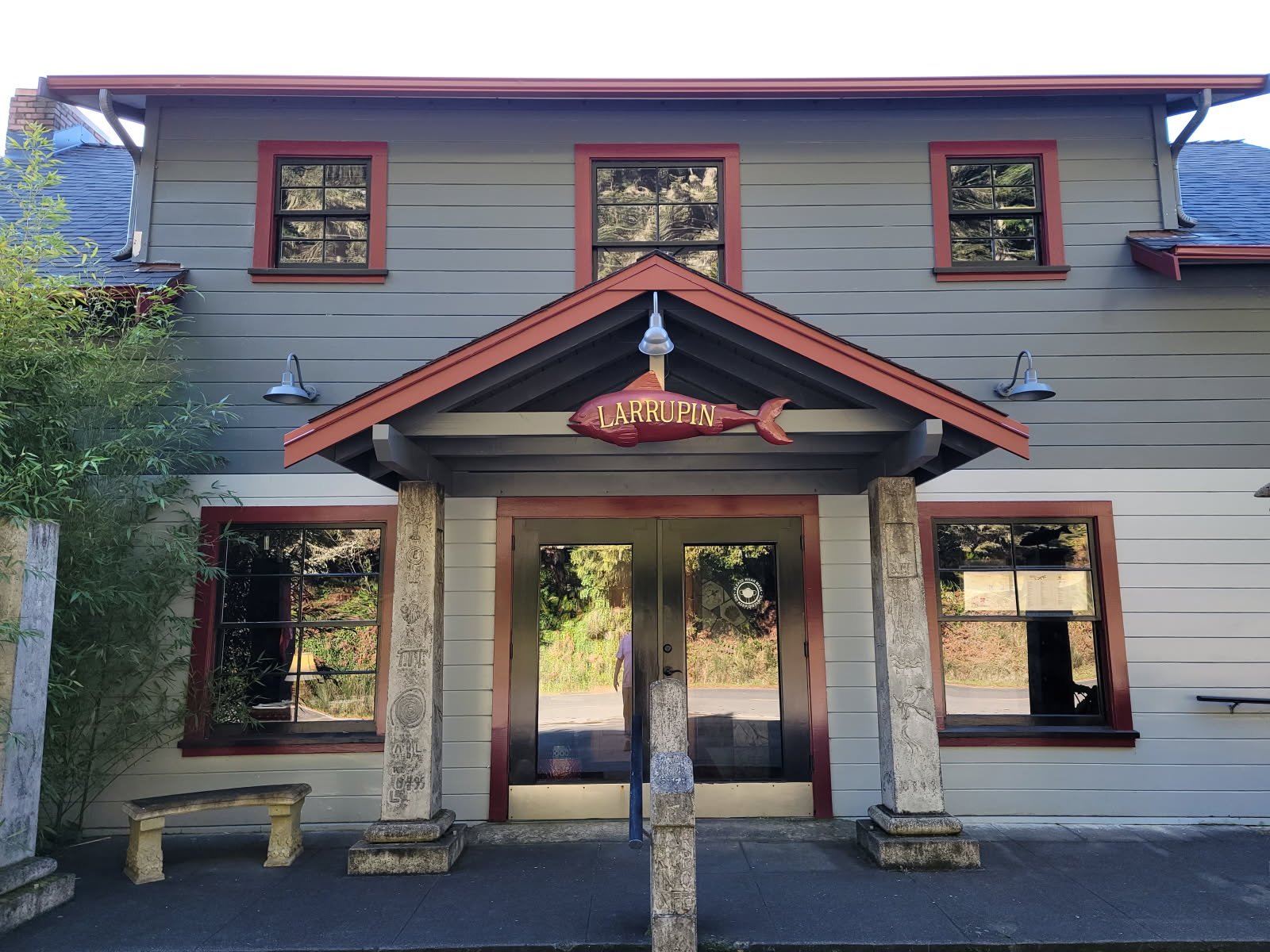 The gray-and-red exterior of Larrupin Cafe in Trinidad, with its fish-shaped sign above the entrance.