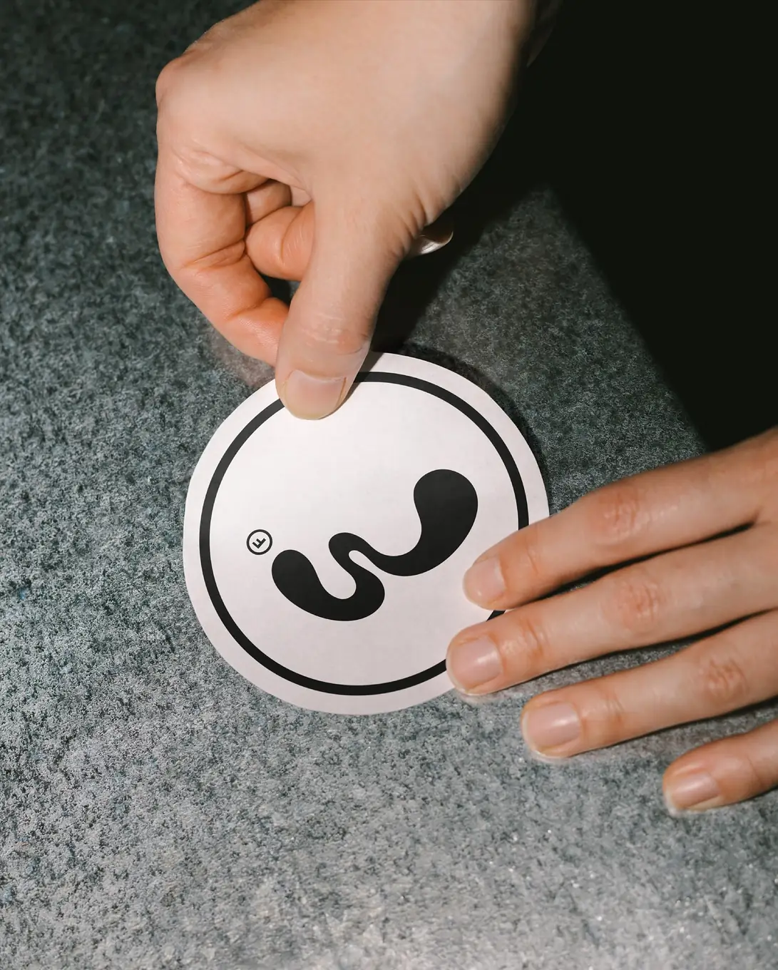 Brand sticker being placed