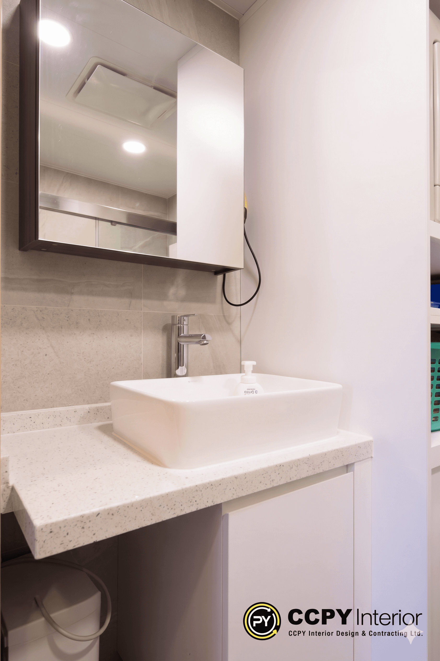 Soft overhead glows illuminate a stone-flecked countertop in Castello, presenting bathroom design ideas modern and tactile for daily rituals.