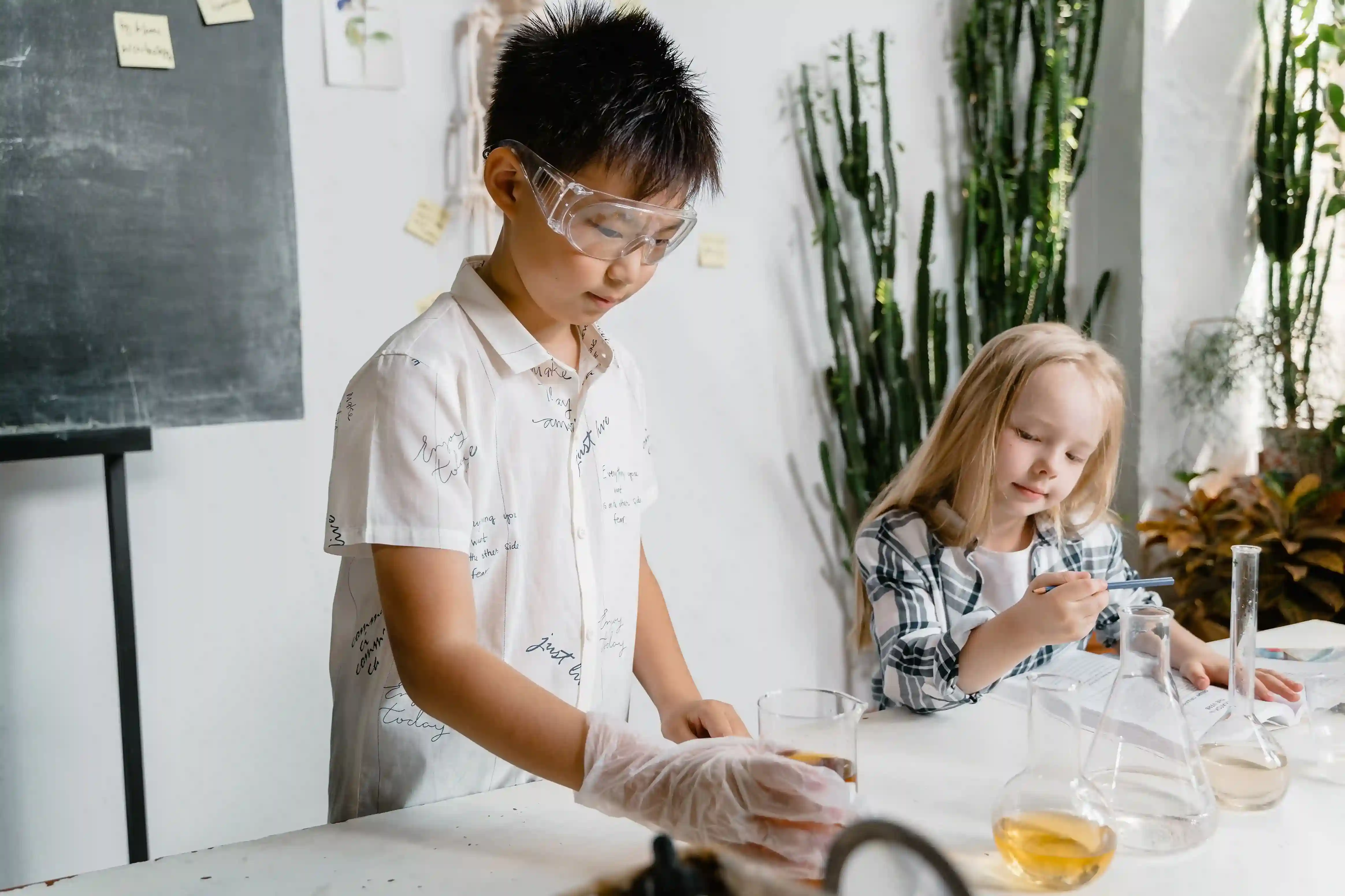 Students participating in a science lesson at a tuition centre in Singapore with age appropriate learning activities structured by level.