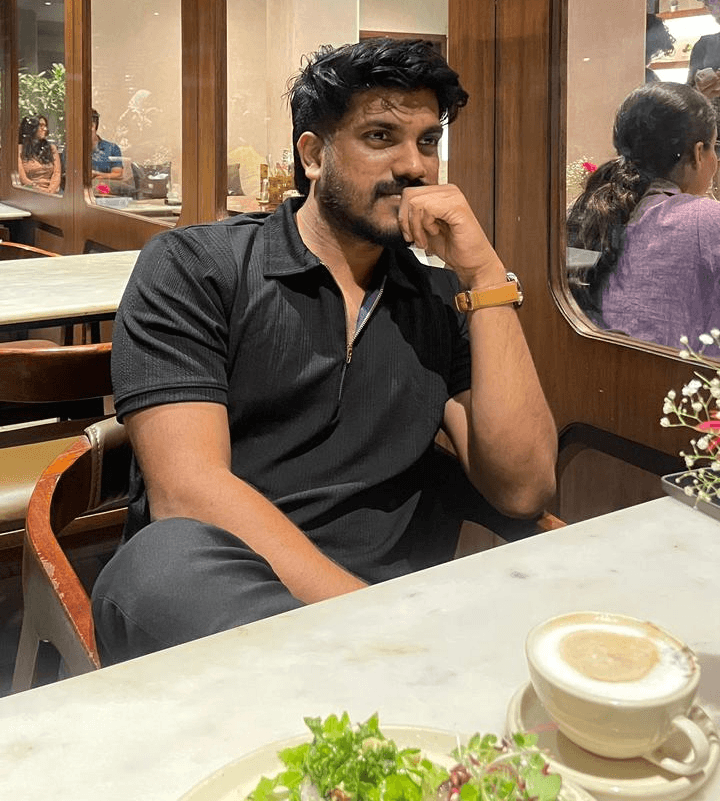 man in gray suit jacket and black pants standing on brown concrete pathway during daytime