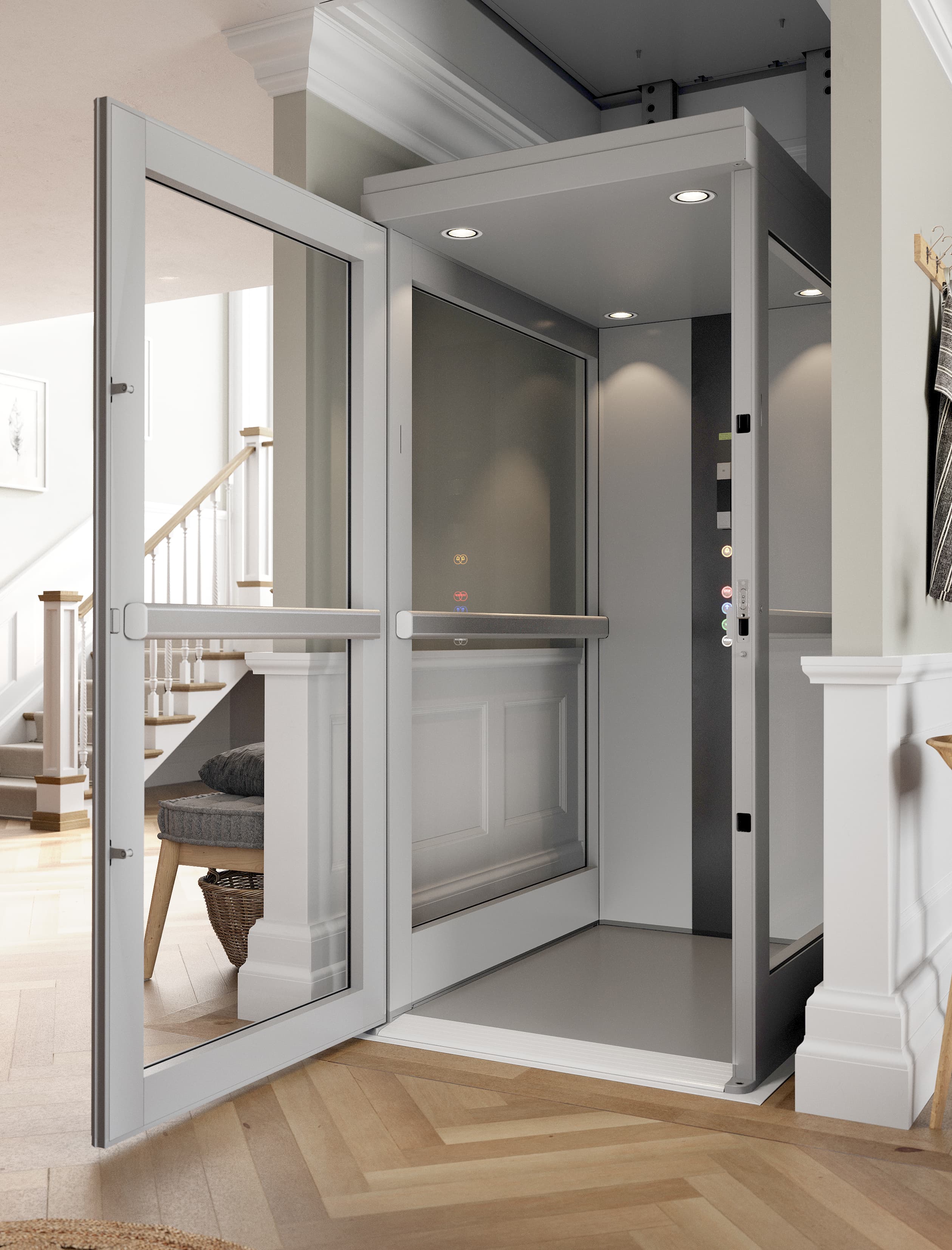 A fully enclosed residential home lift with automatic glazed doors open at ground level, installed in a domestic hallway beside a traditional staircase, showing the illuminated interior cabin and colour-coded floor controls.