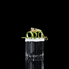 A closeup of a Black Gold drink against a dark background.