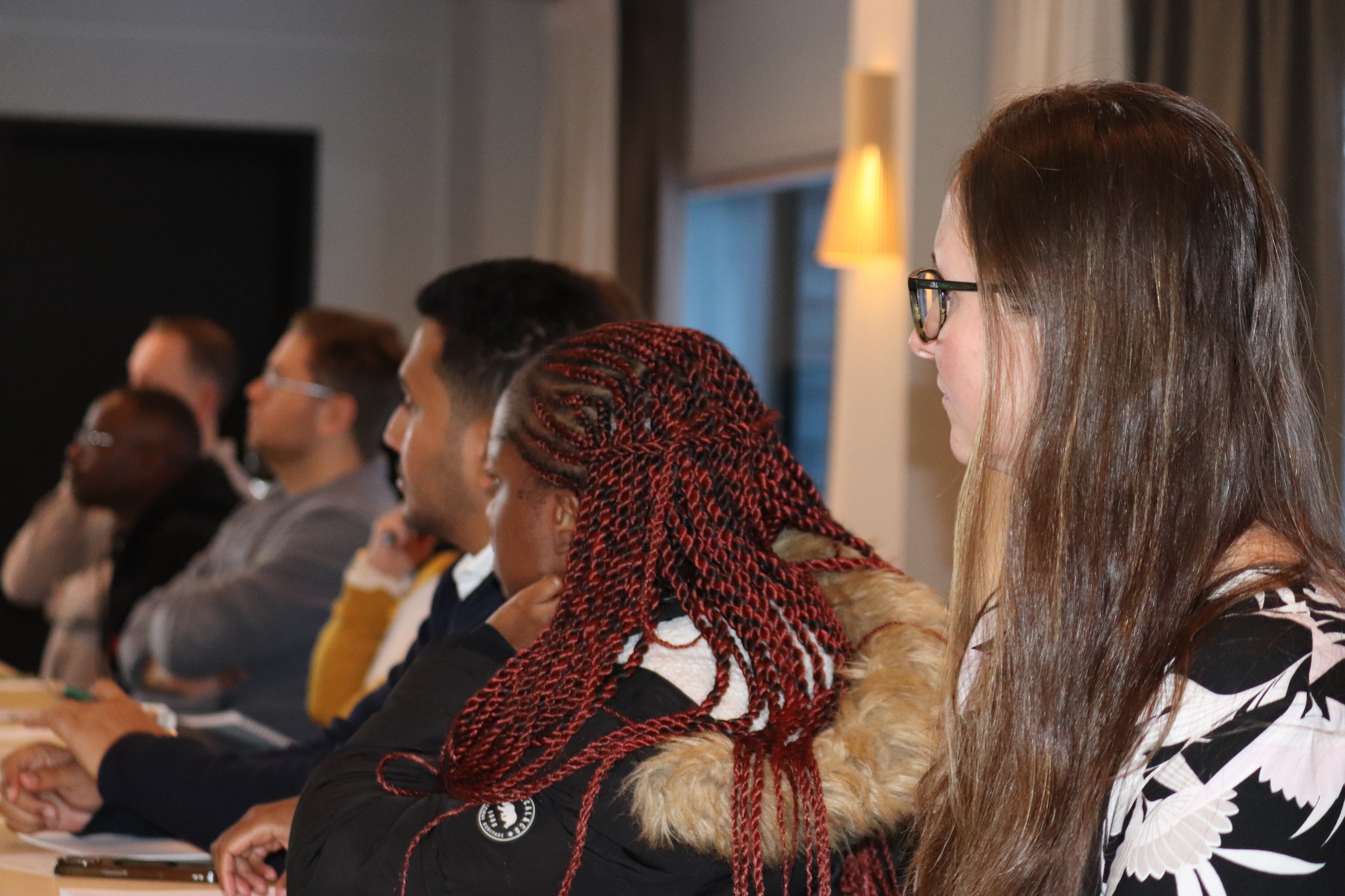 Six people giving theier attention to a presentation