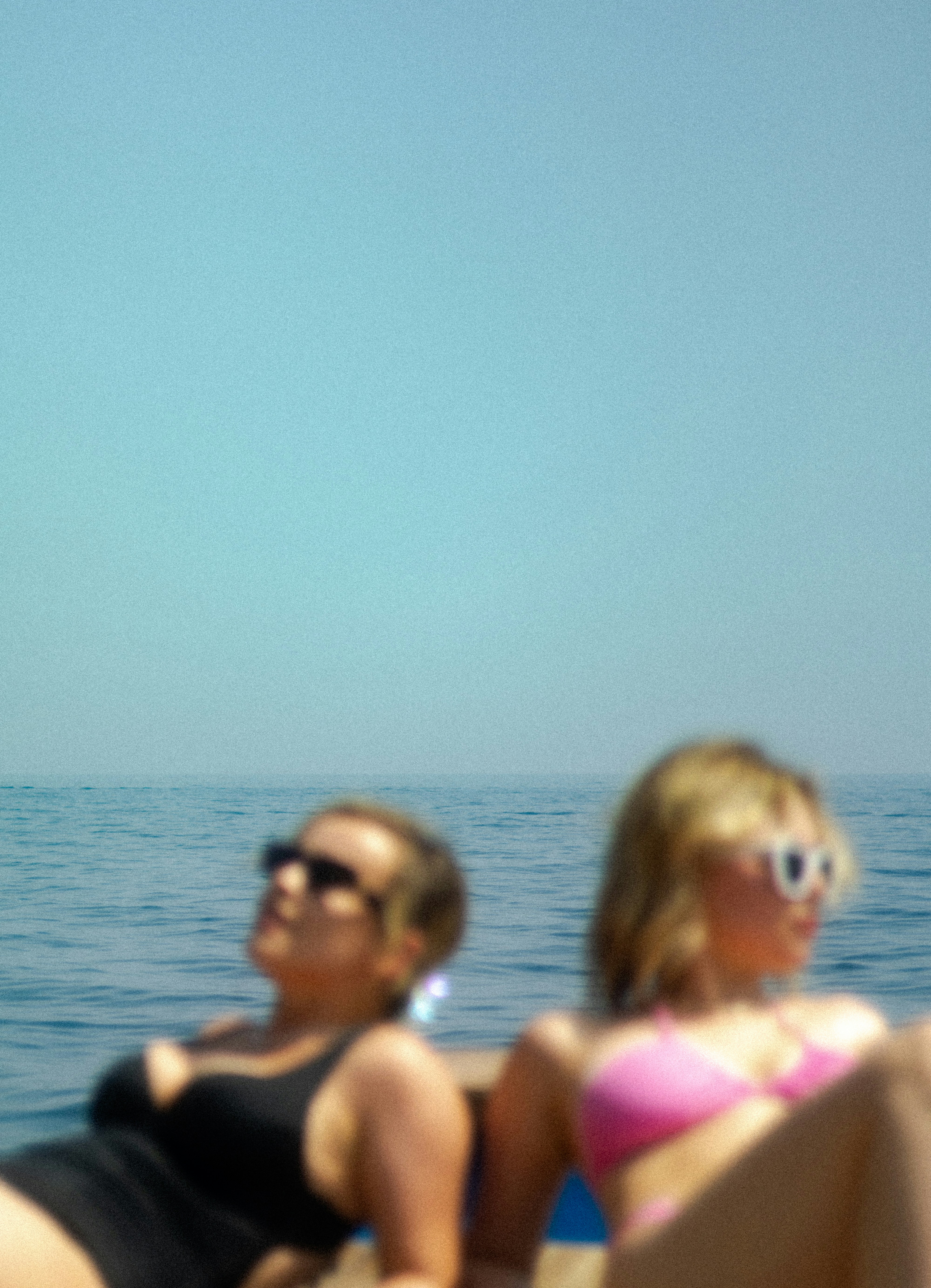 A couple of women sitting on top of a boat