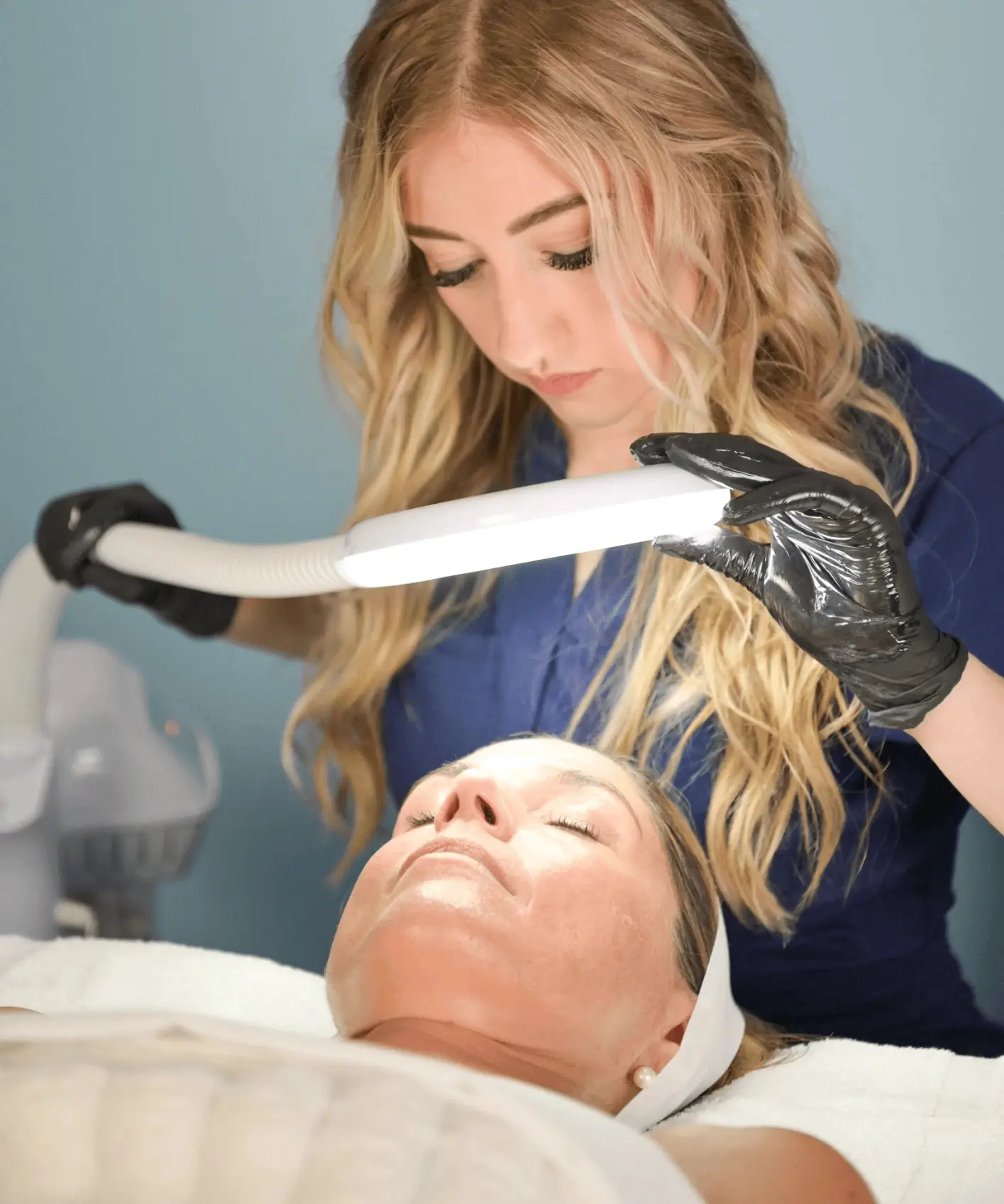 Esthetician performing a facial treatment at Skinfinity & Beyond in Lake Norman, NC