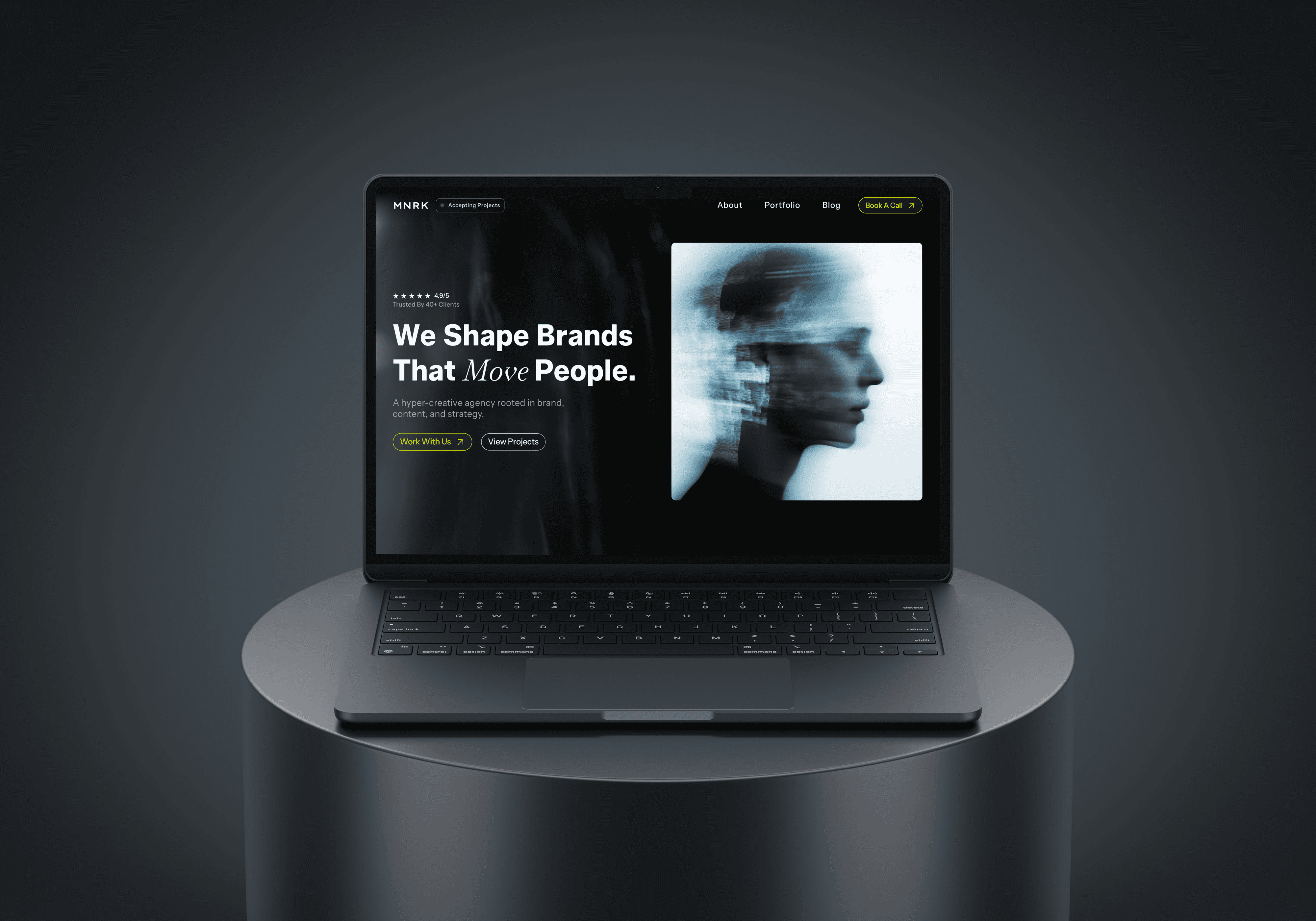 laptop on metal stand with dark background