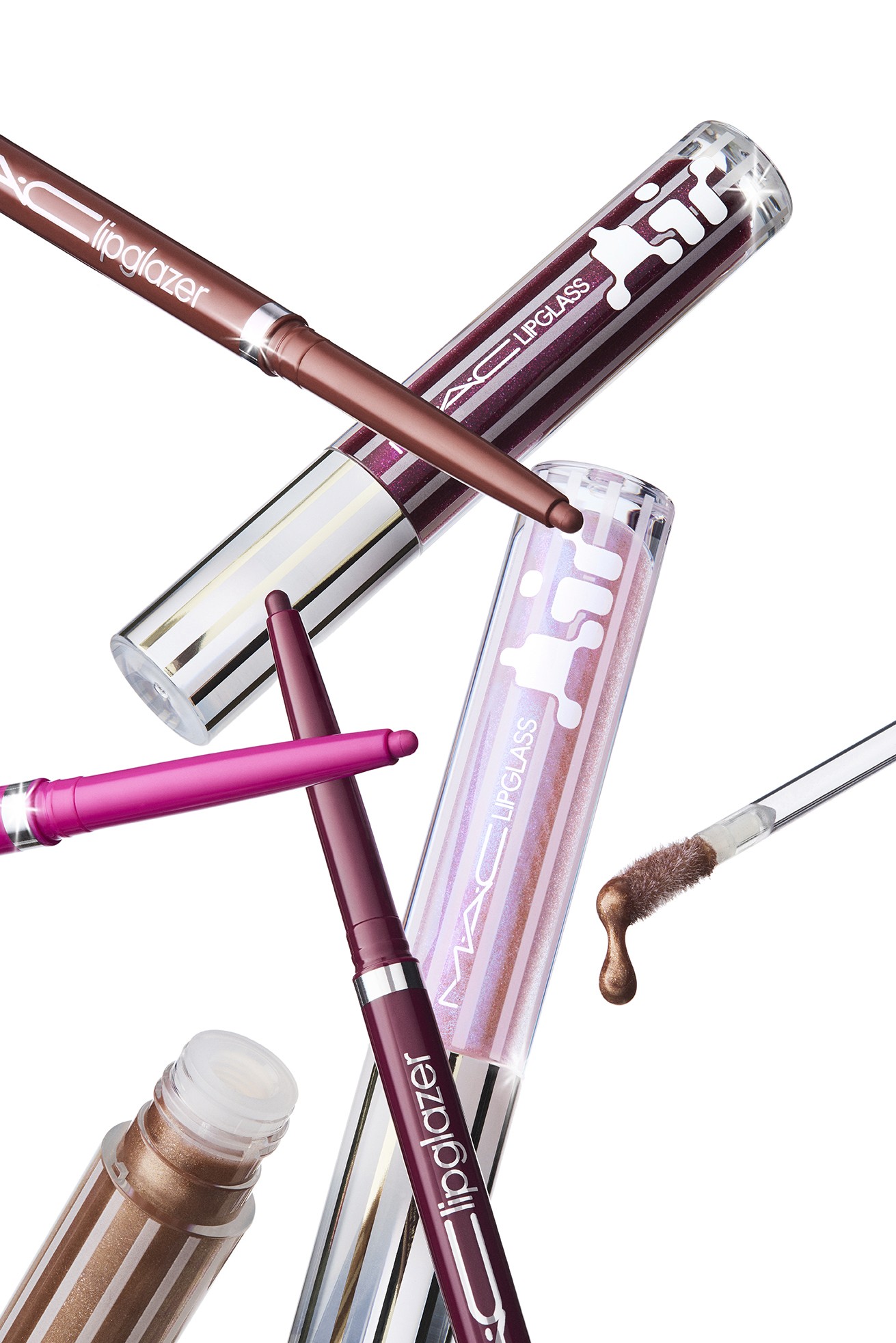 A collection of various lip products from M.A.C, including lipgloss, lipglazers, and lip pencils, arranged together against a bright background.