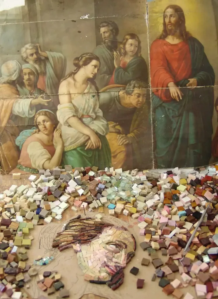 Religious mosaic featuring Mary Magdalene and John 8:7, crafted with colorful tiles.
