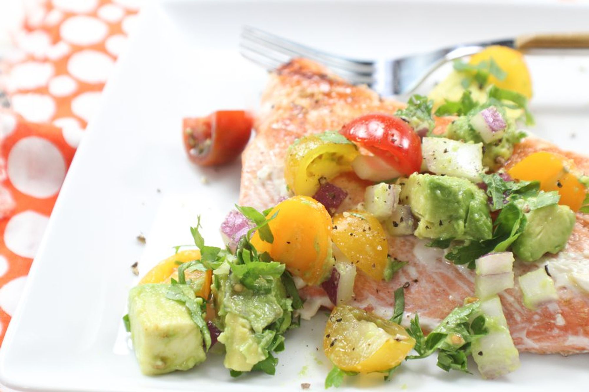 seared salmon with avocado salsa served in a big plate
