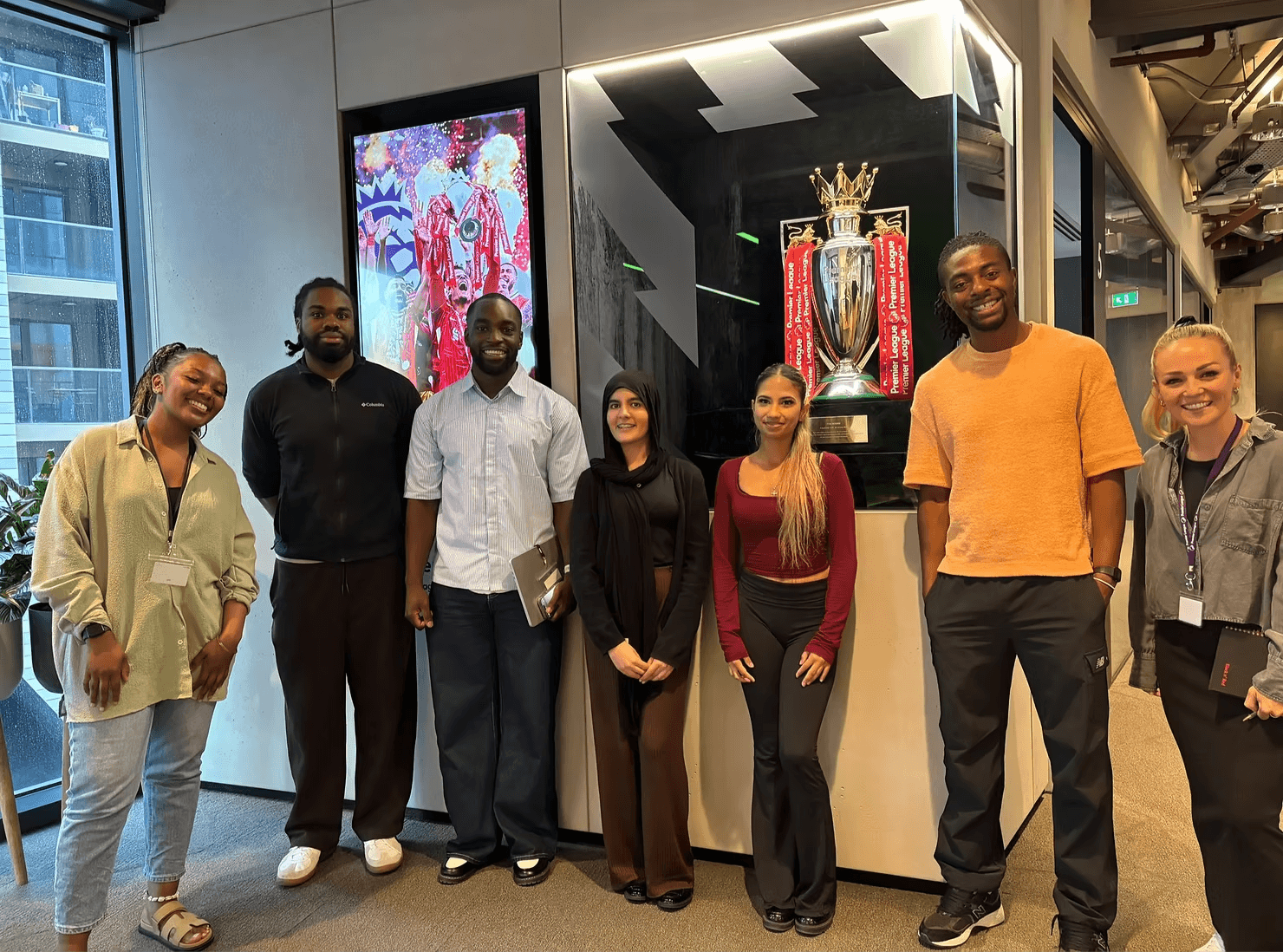 two people in a workspace working on their laptops