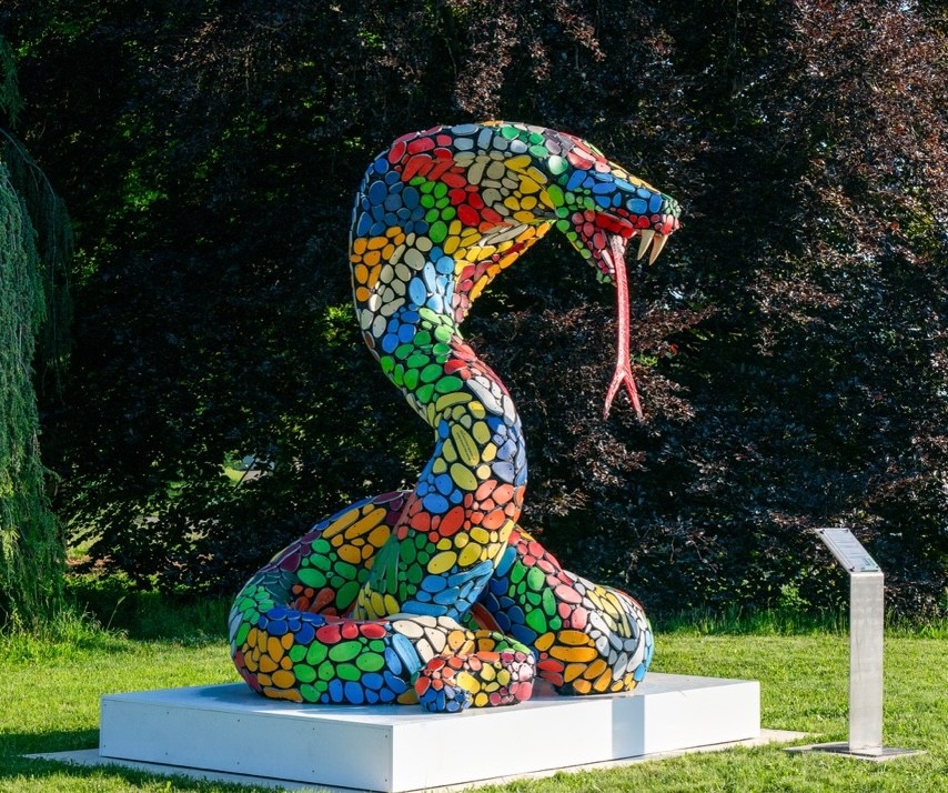 Woman wears a blue coat in a blue environment.