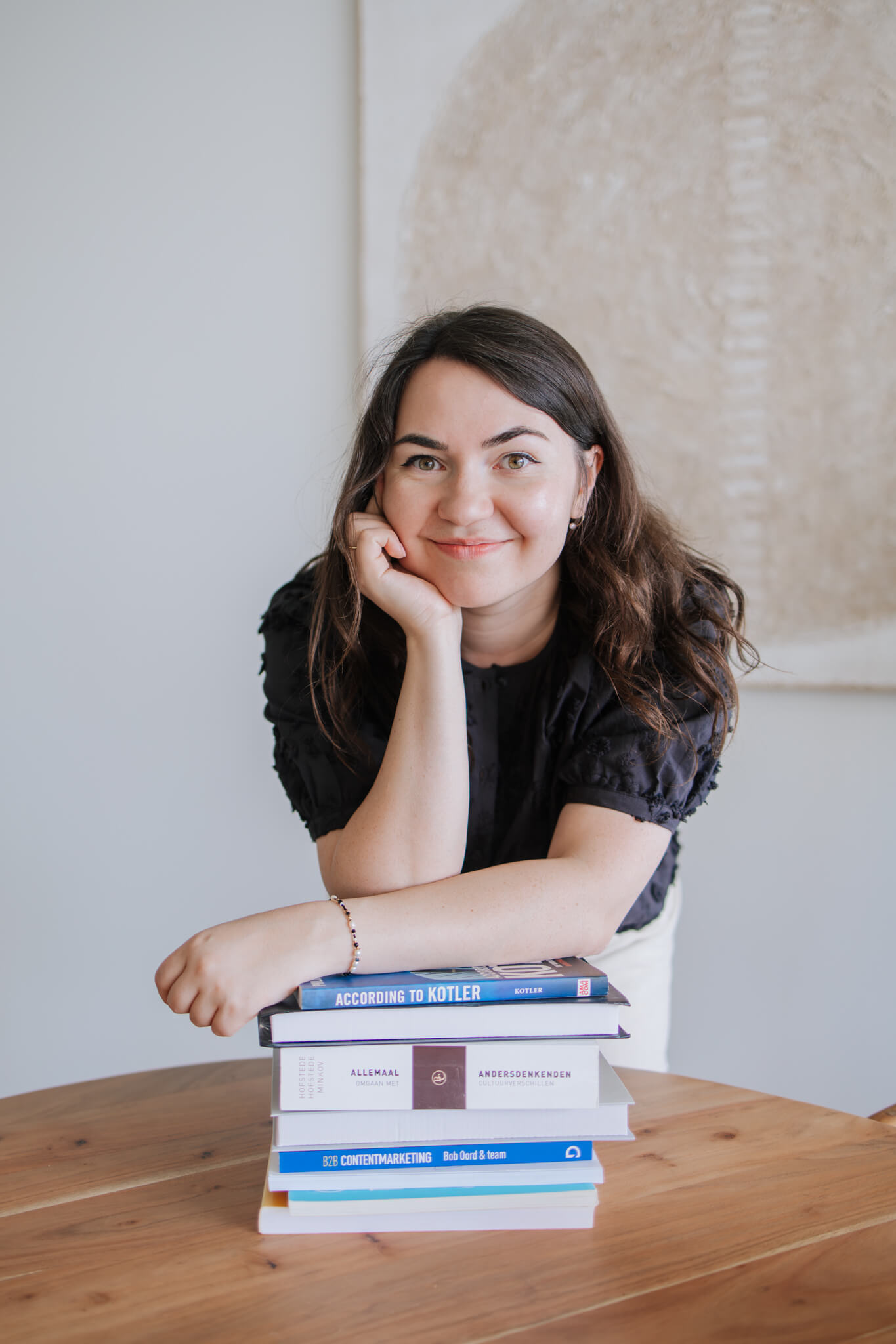 Portrait of a person in a pink sweater against a light background
