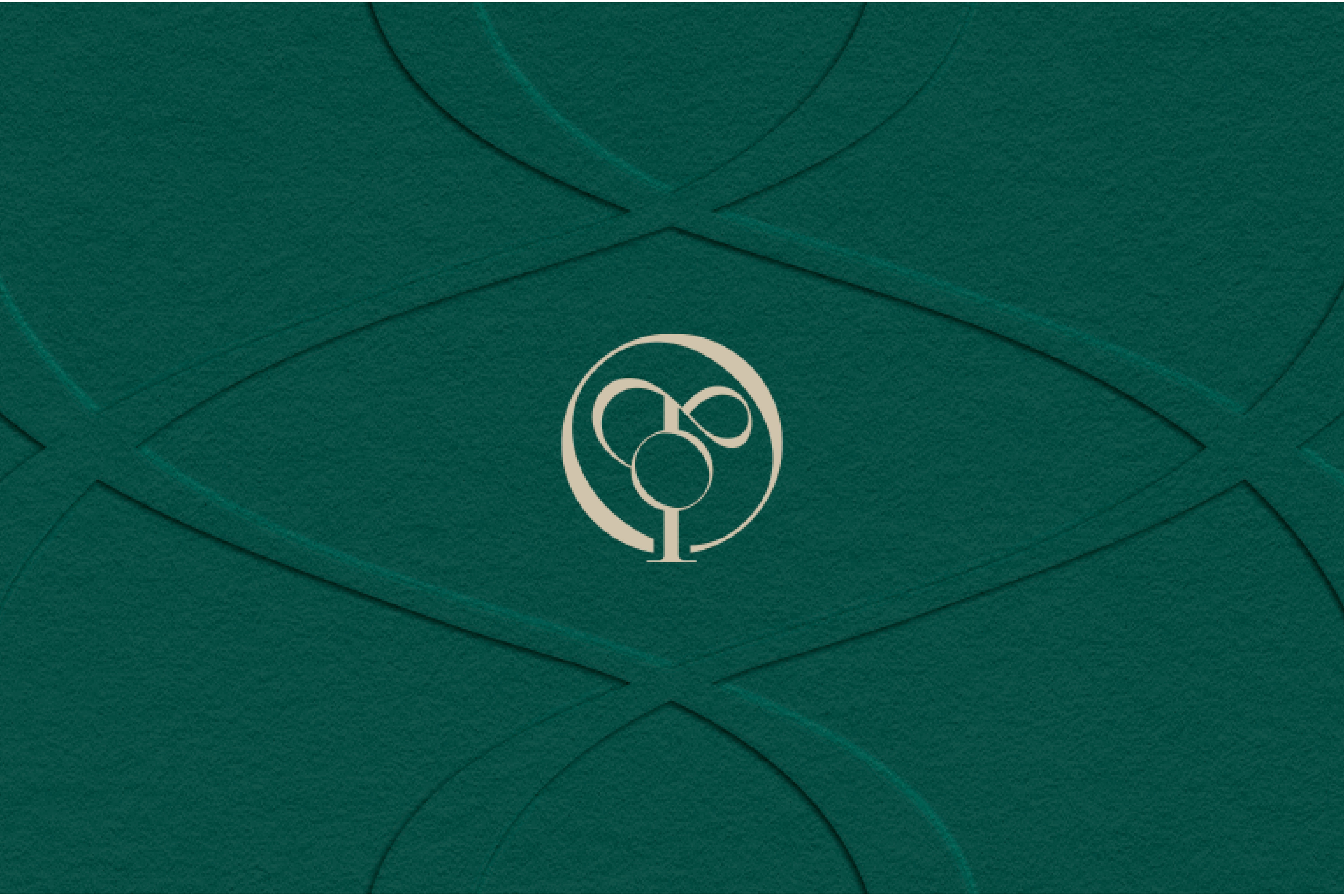 Luxury embossed brand identity – Onetone’s monogram logo embossed on textured green paper, symbolizing elegance and cultural heritage in Middle Eastern fashion.