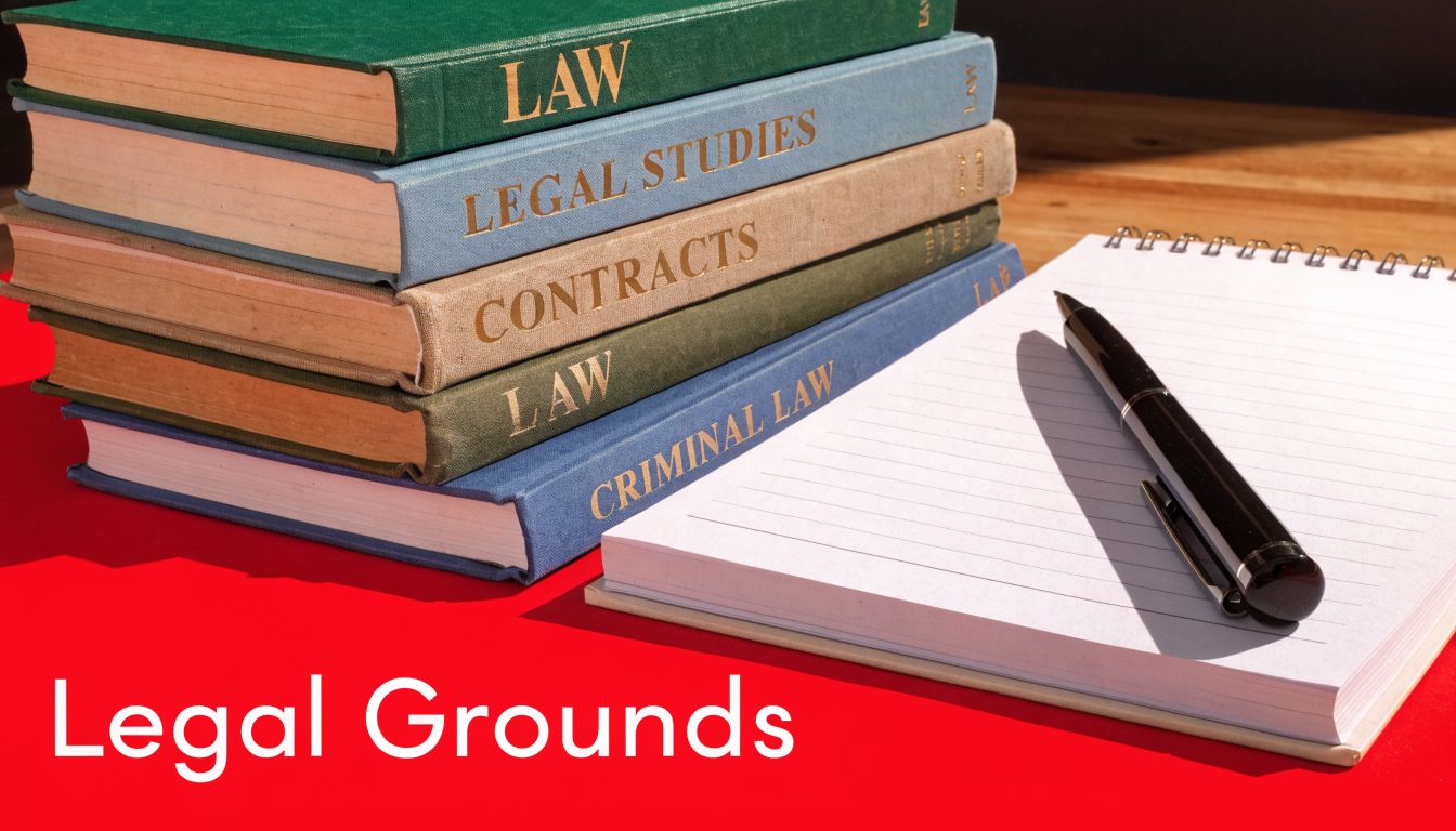 A stack of law textbooks and a notebook with a pen sitting on a red surface.