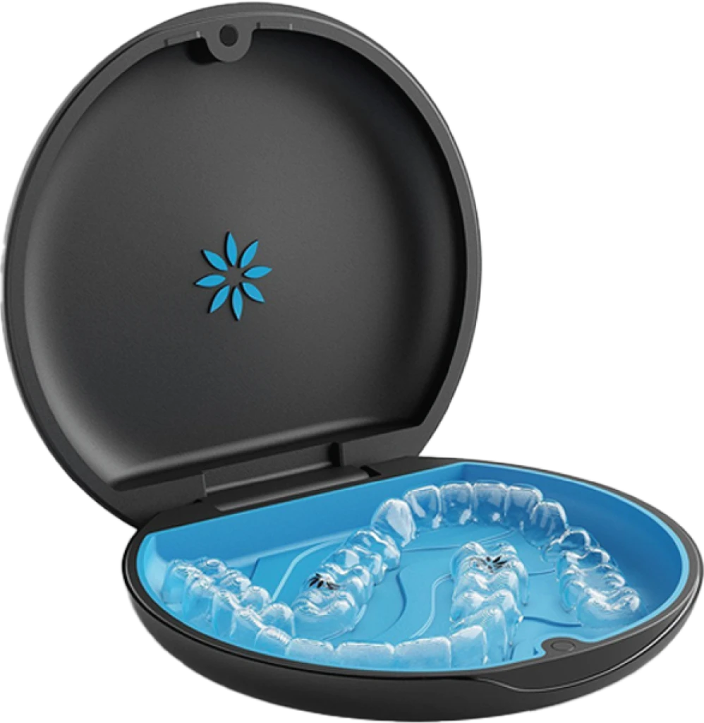 A woman smiles and holds invisalign clear aligners with a case, showcasing a certified invisalign provider at Bella Medical Centre