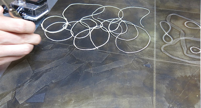 string on a metal plate