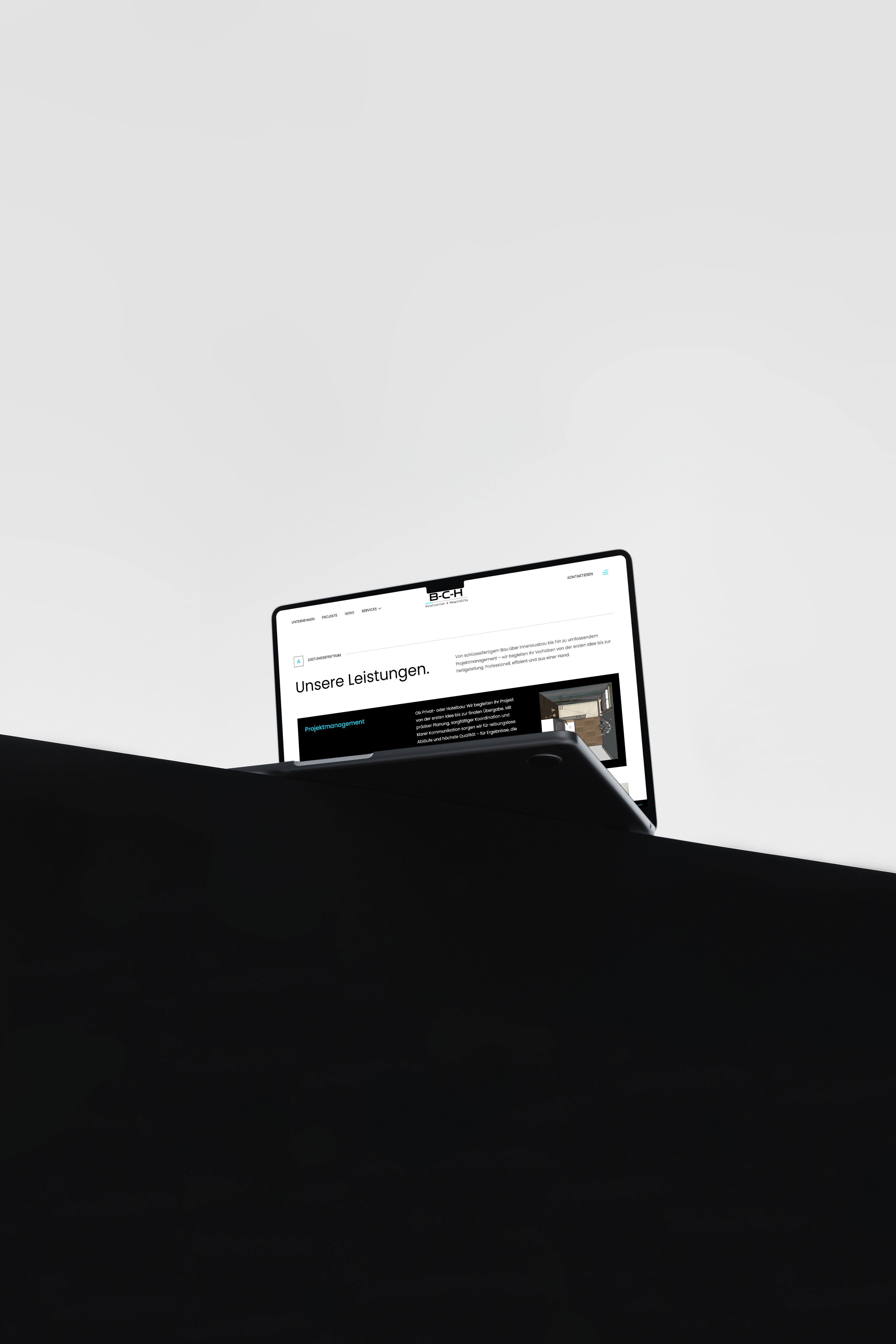 A fast black sports car races down the highway.