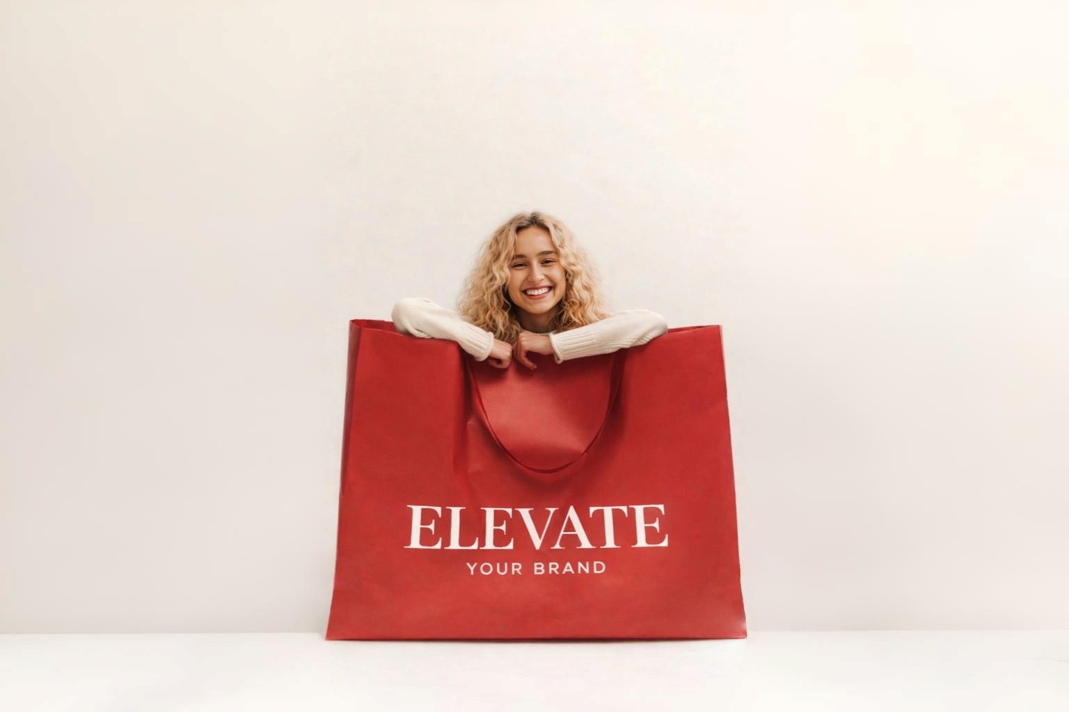 A woman stands holding a bright red shopping bag, smiling as she enjoys her shopping experience.